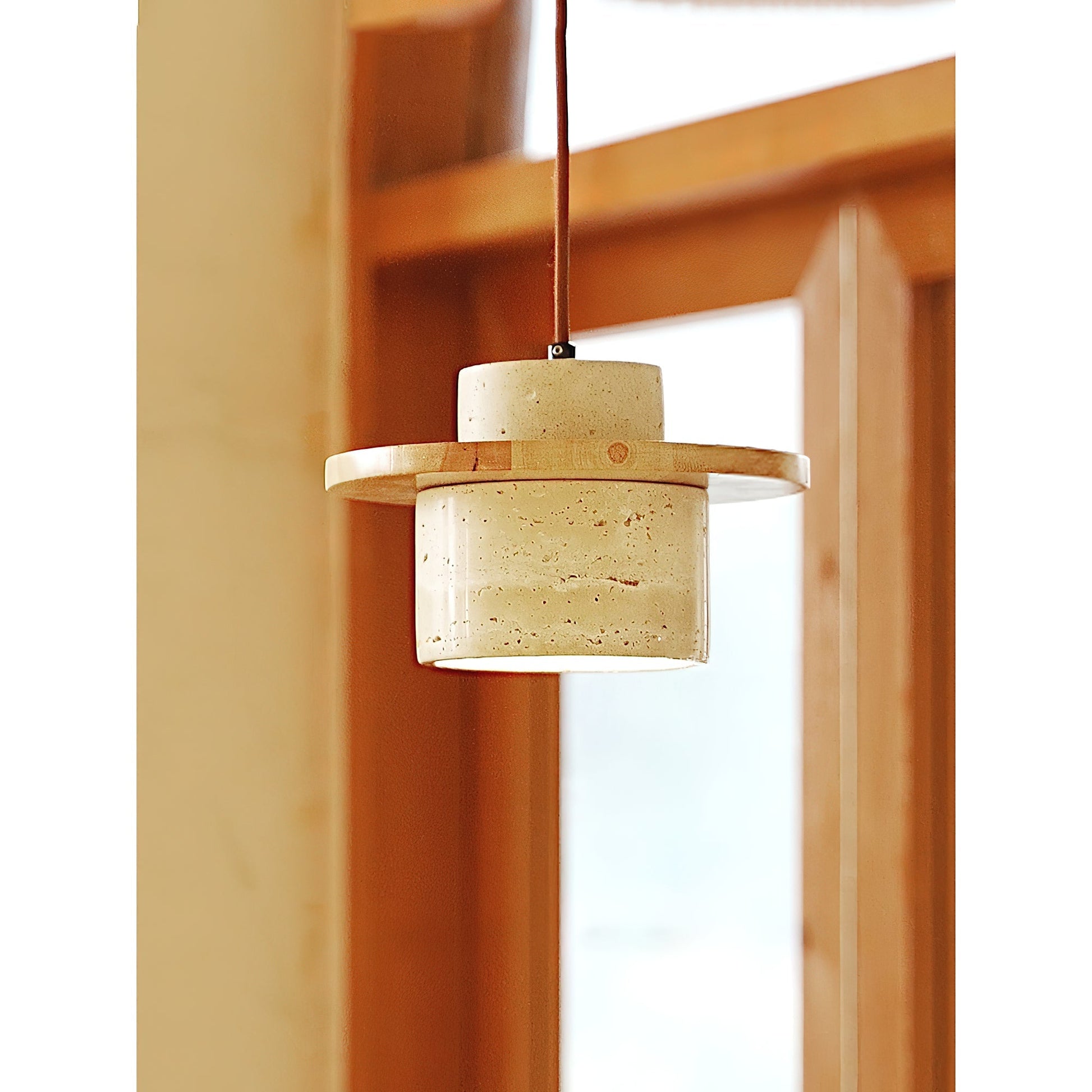 Detail shot highlighting the junction of the wood and travertine materials.