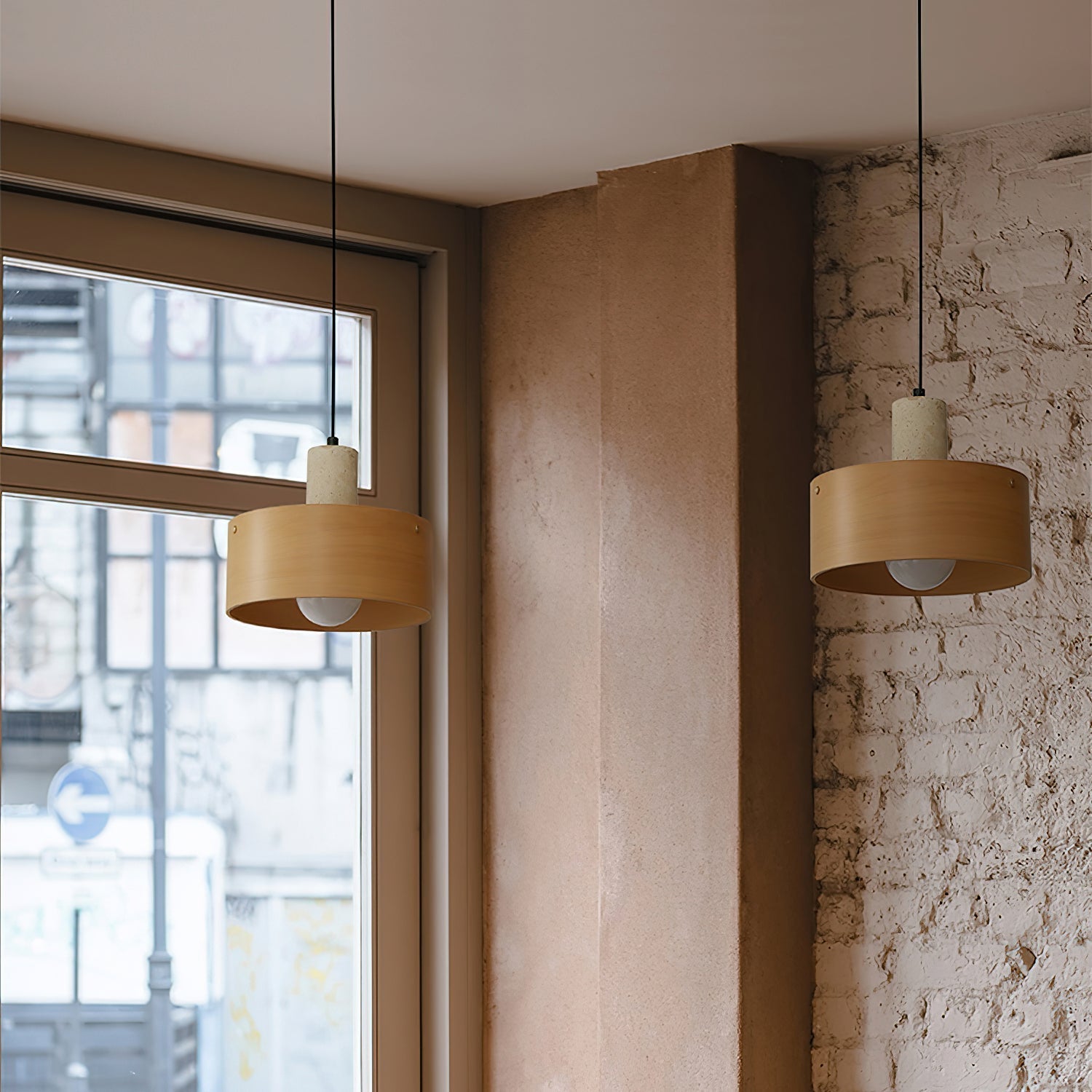 The Tako Pendant Lamp illuminated, casting a warm and inviting glow.