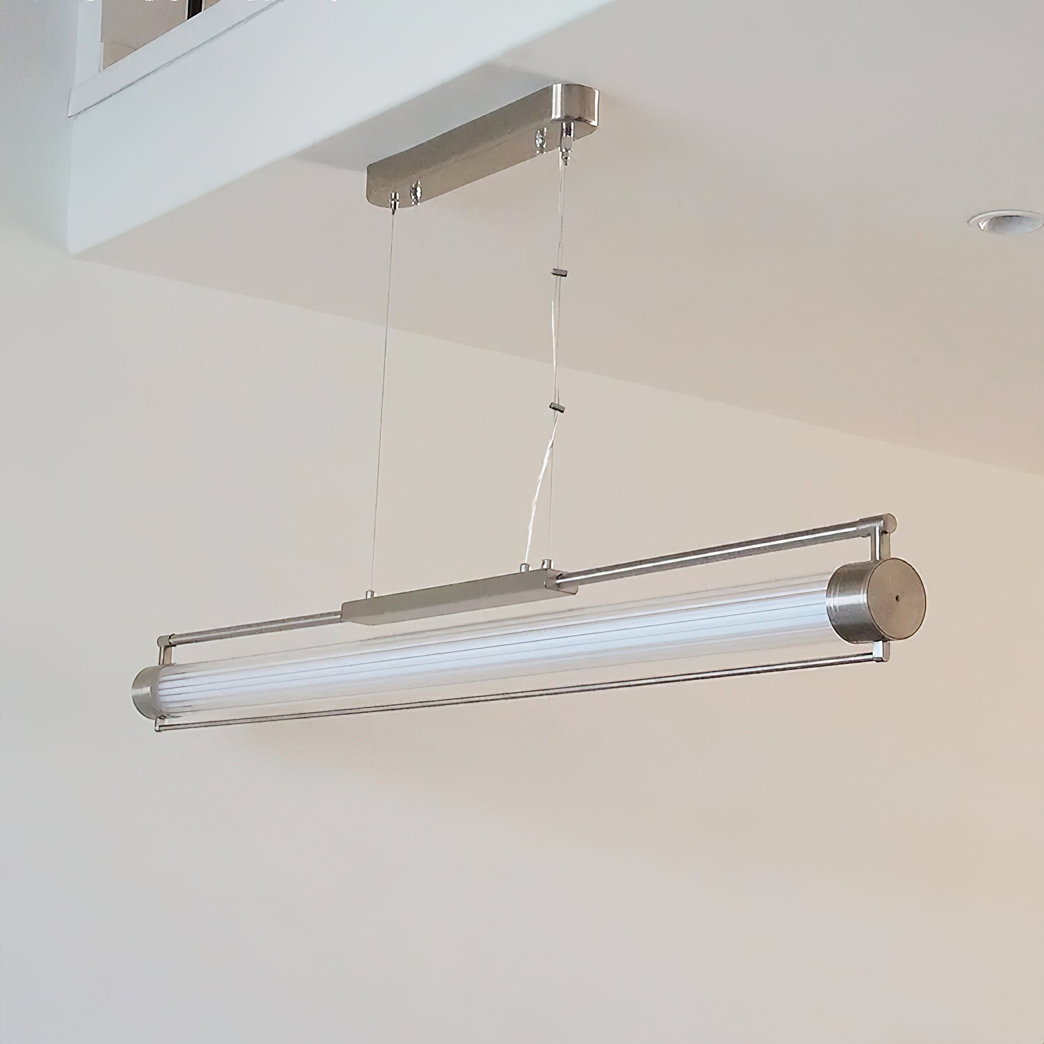 Angled view of the Tamar Wand Pendant Lamp, emphasizing its tubular form.
