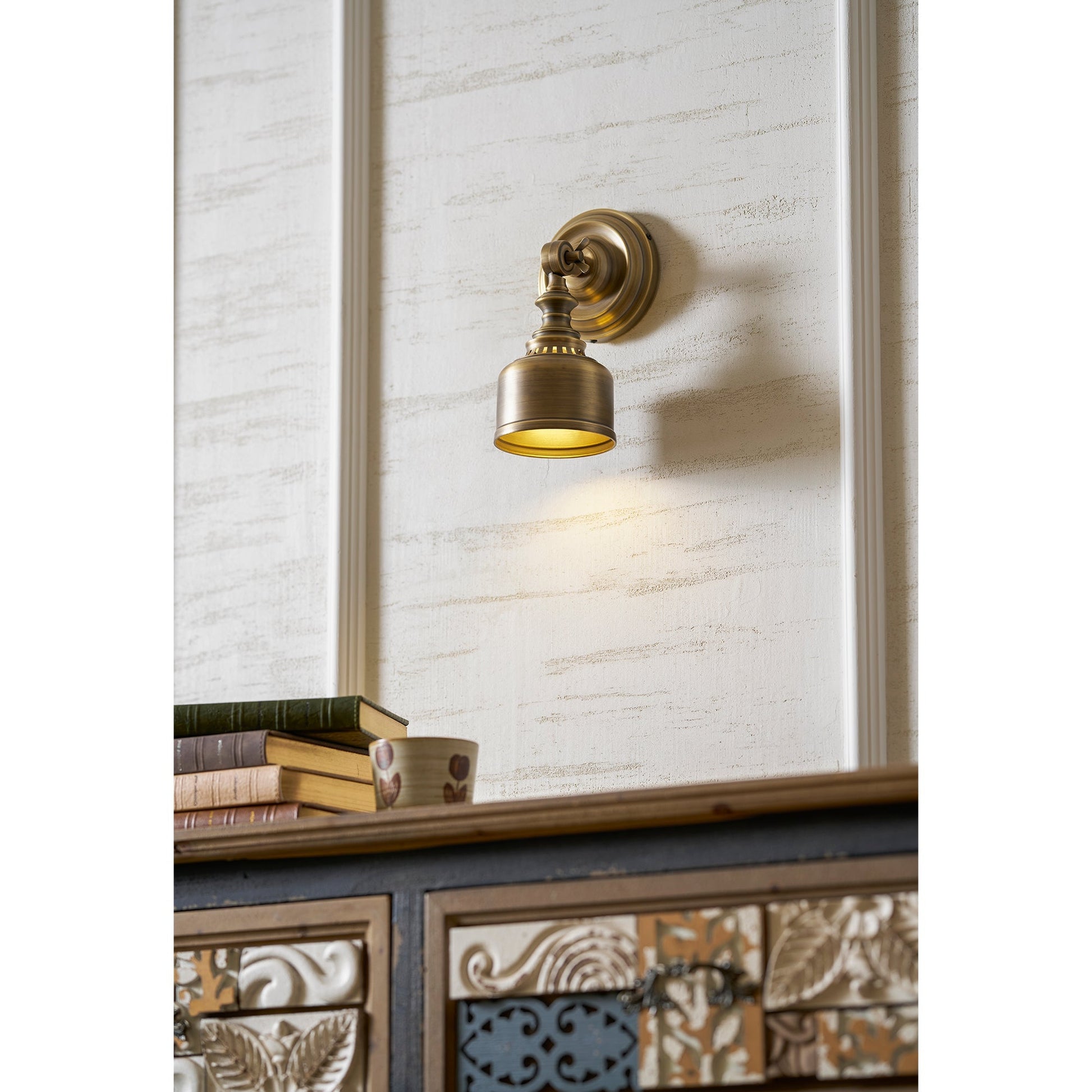 The lamp casting a warm glow downwards in a dimly lit room.