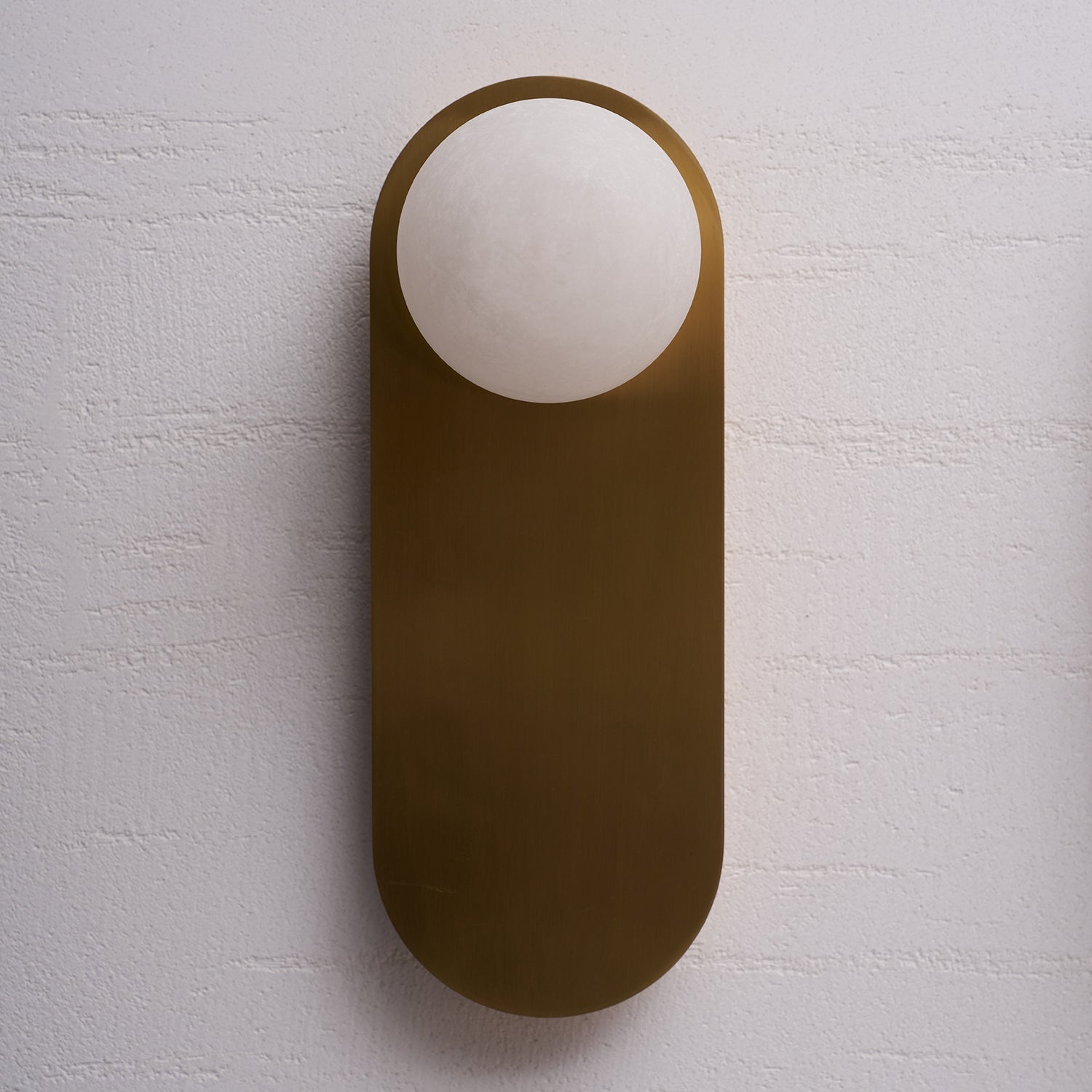 Front profile of a flat-mounted alabaster sconce.