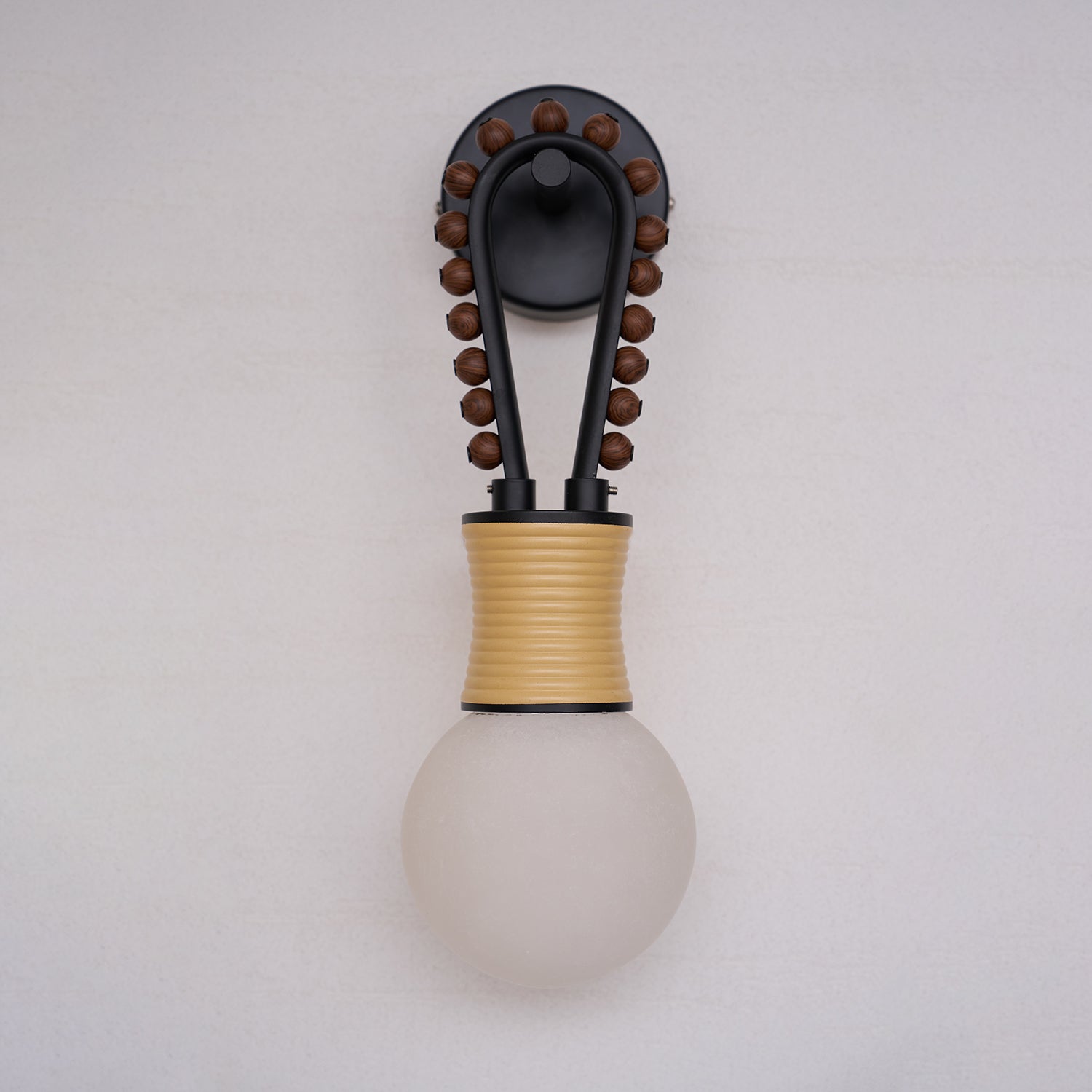 A cluster of different alabaster sconces shown together.