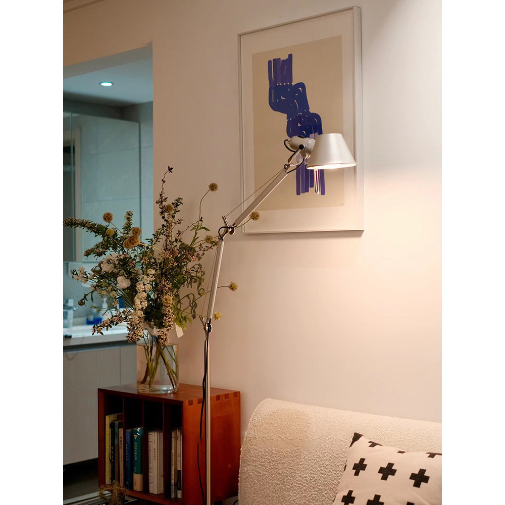 Angled view of the black floor lamp, highlighting its sleek profile.