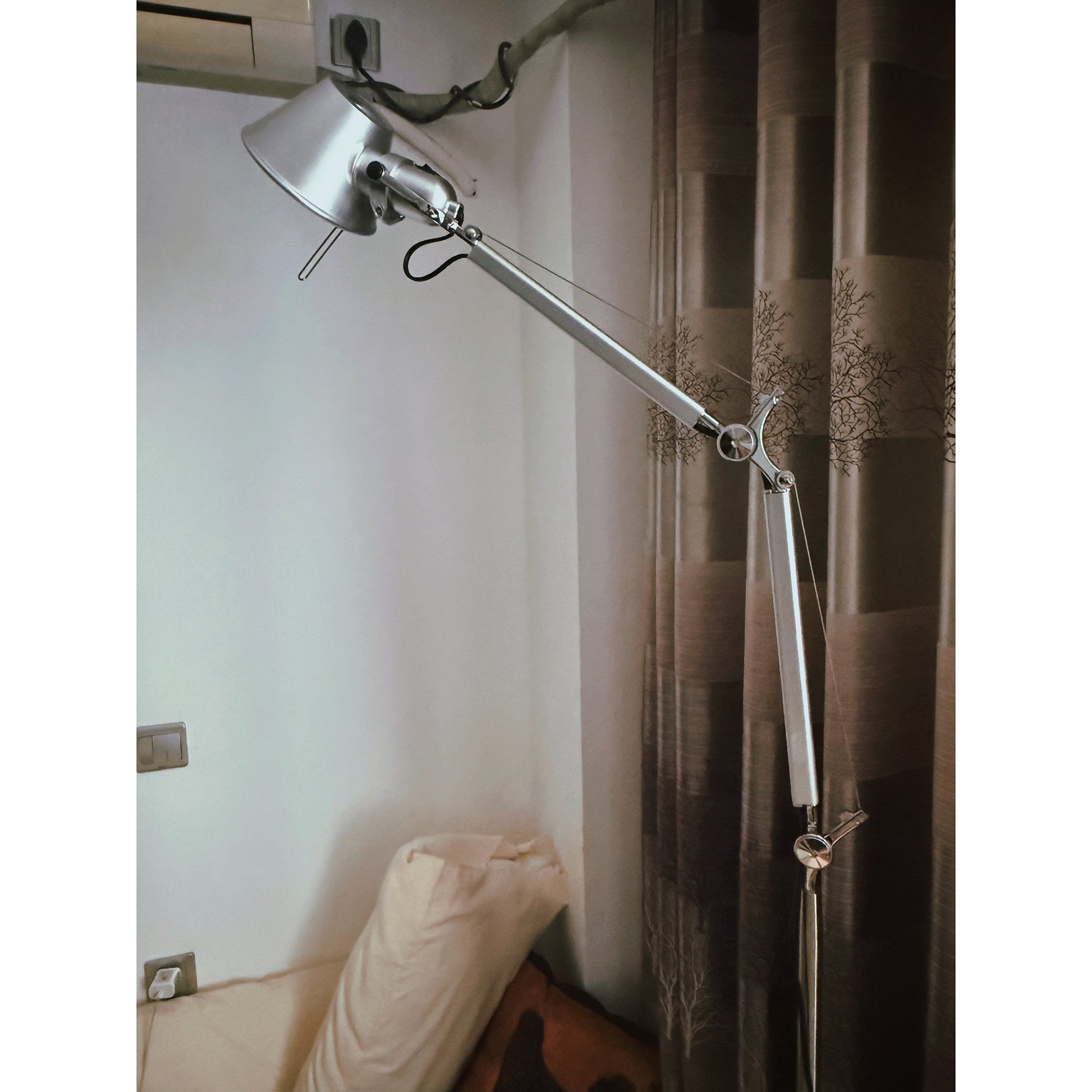 Angled view of the silver floor lamp, showing its articulated arm.