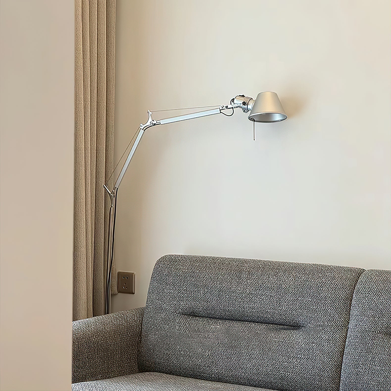The shorter version of the Brady floor lamp by an armchair.