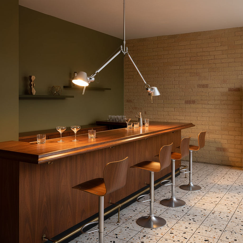 The lamp hanging over a kitchen island, providing focused light.