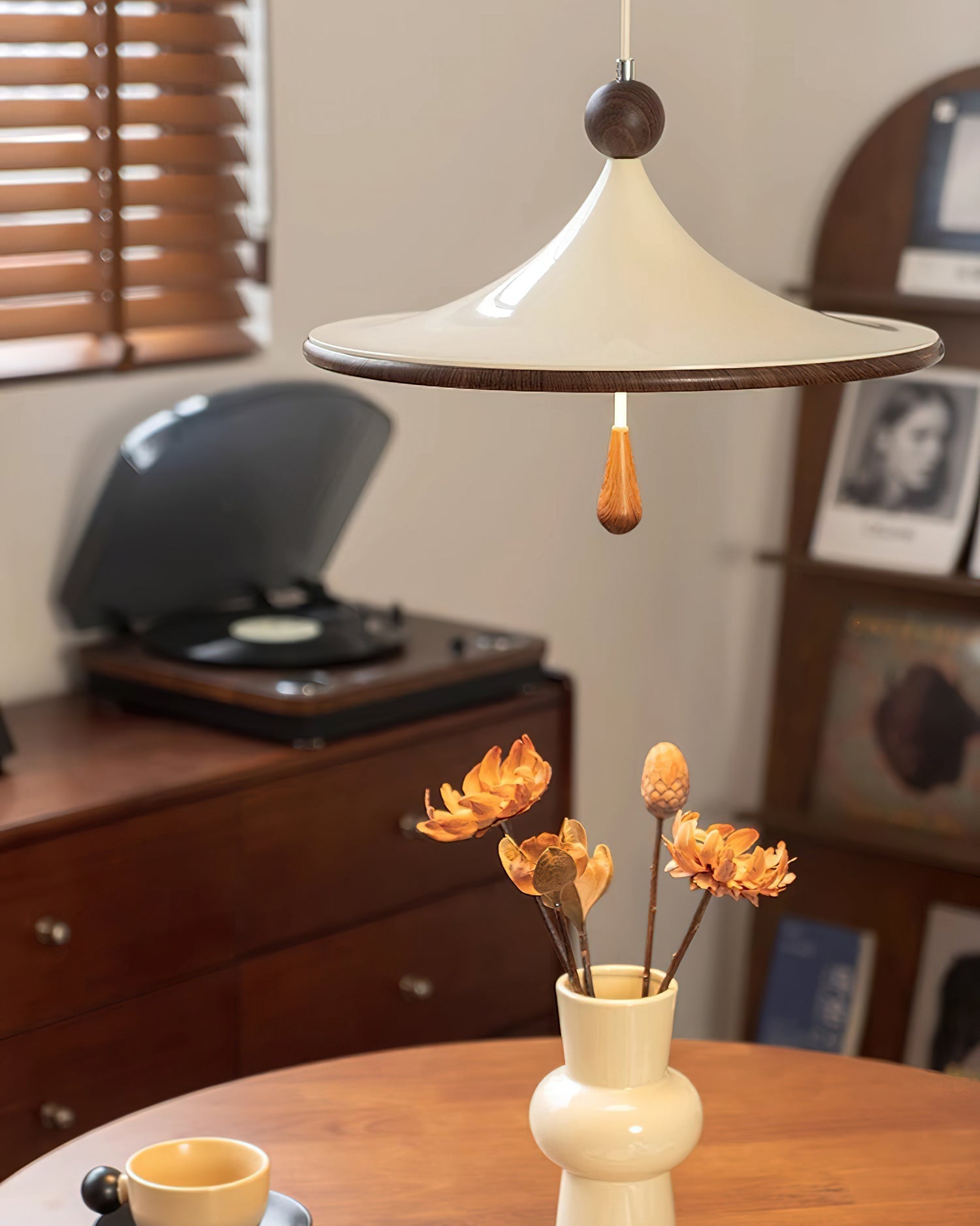 Tomaso Pendant Light hanging over a modern dining table.