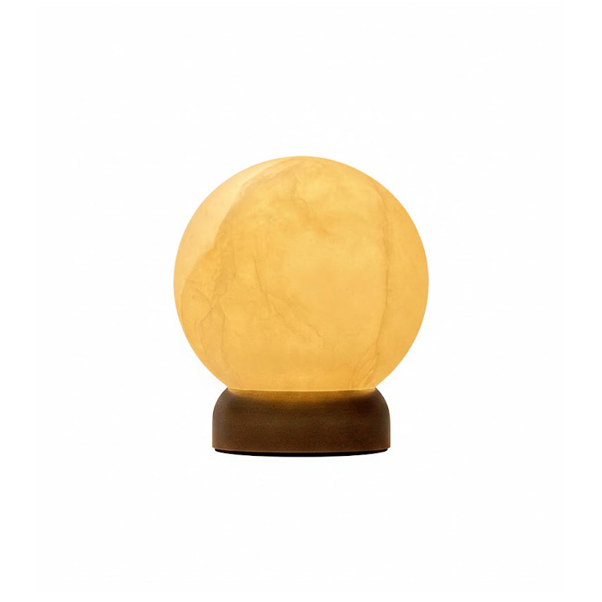 Trevi Table Lamp in alabaster and dark bronze, shown on a side table.