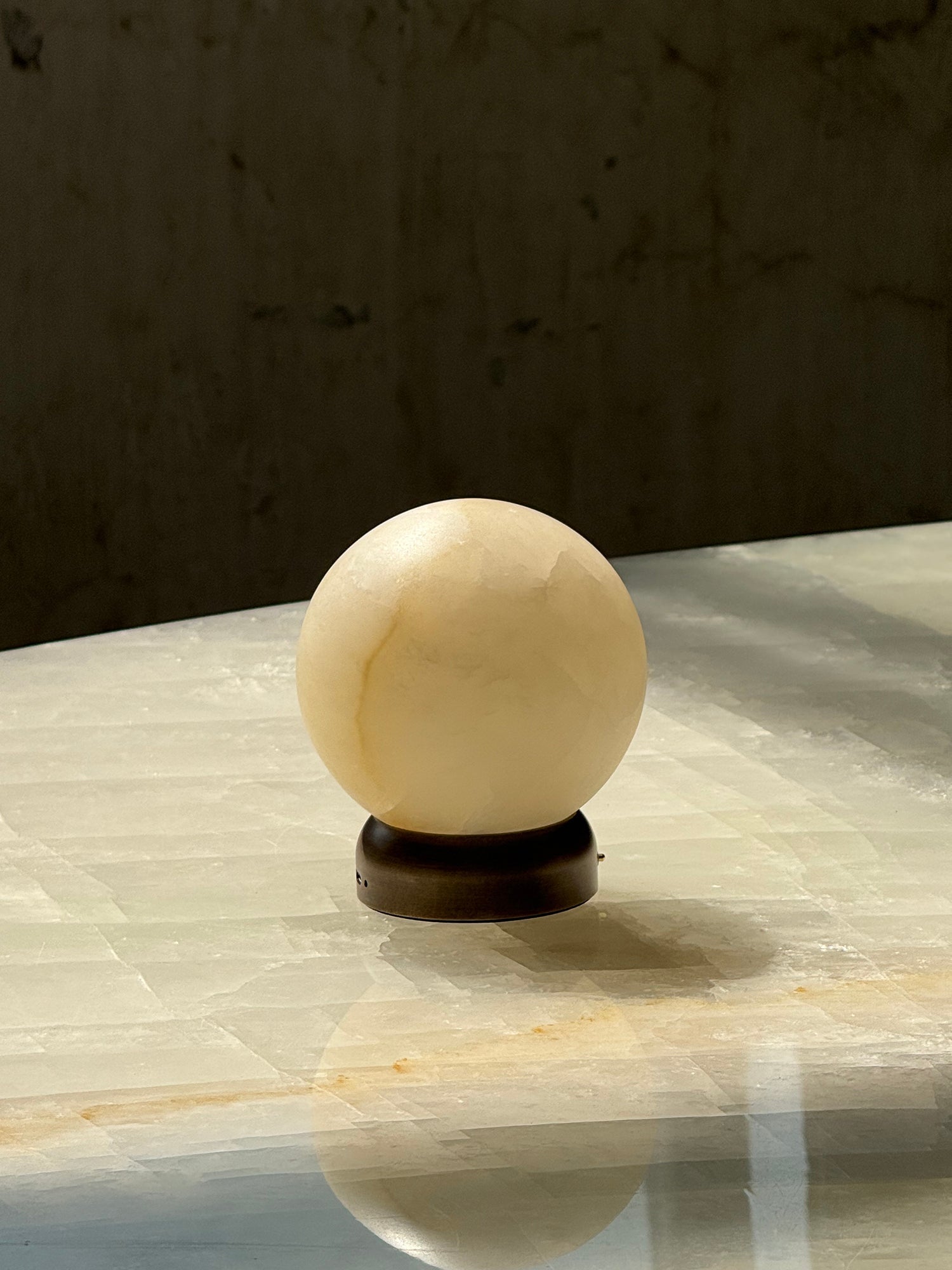 Close-up of the warm light filtering through the alabaster shade.