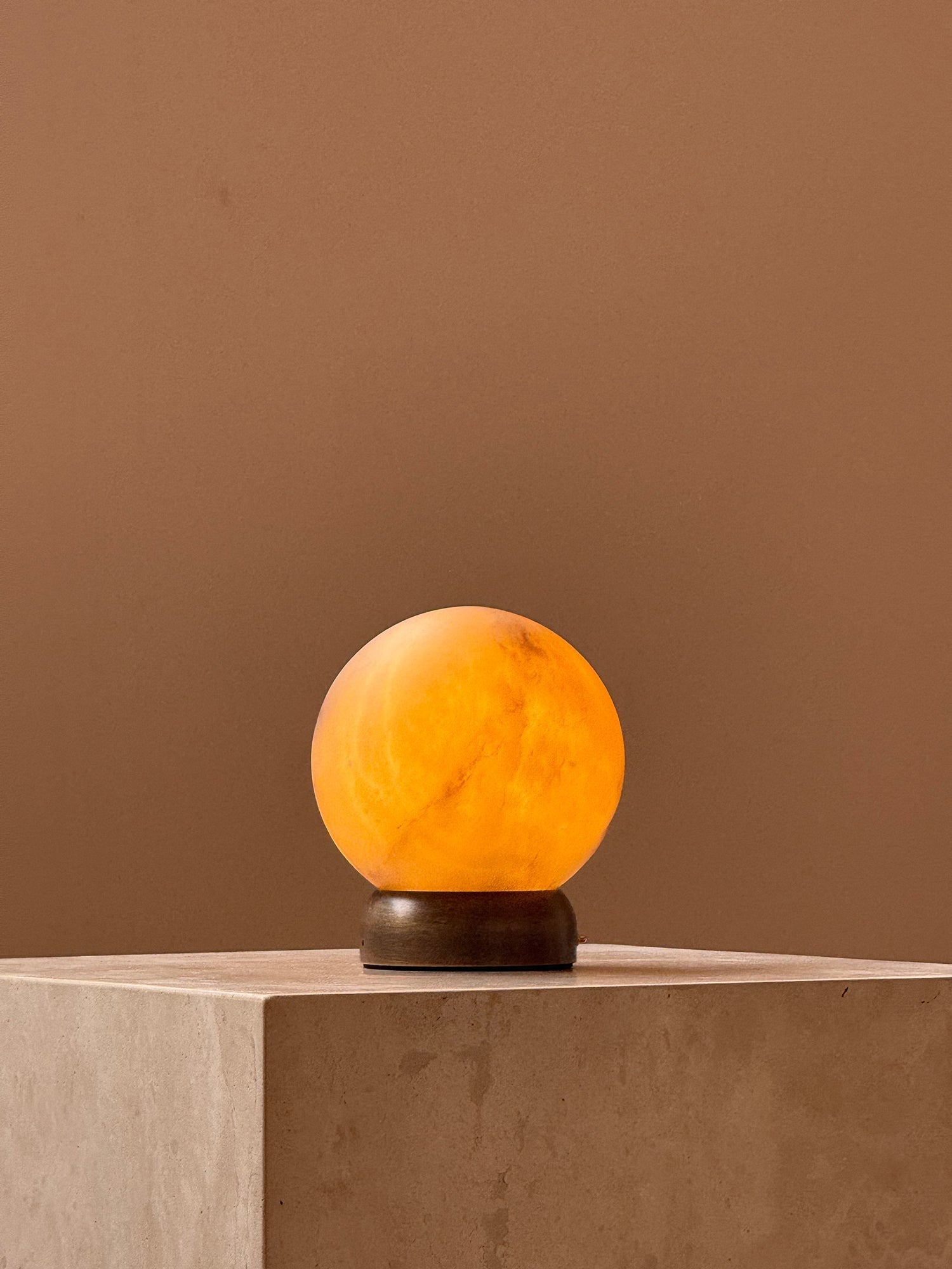 Trevi Table Lamp against a dark background to emphasize its glow.