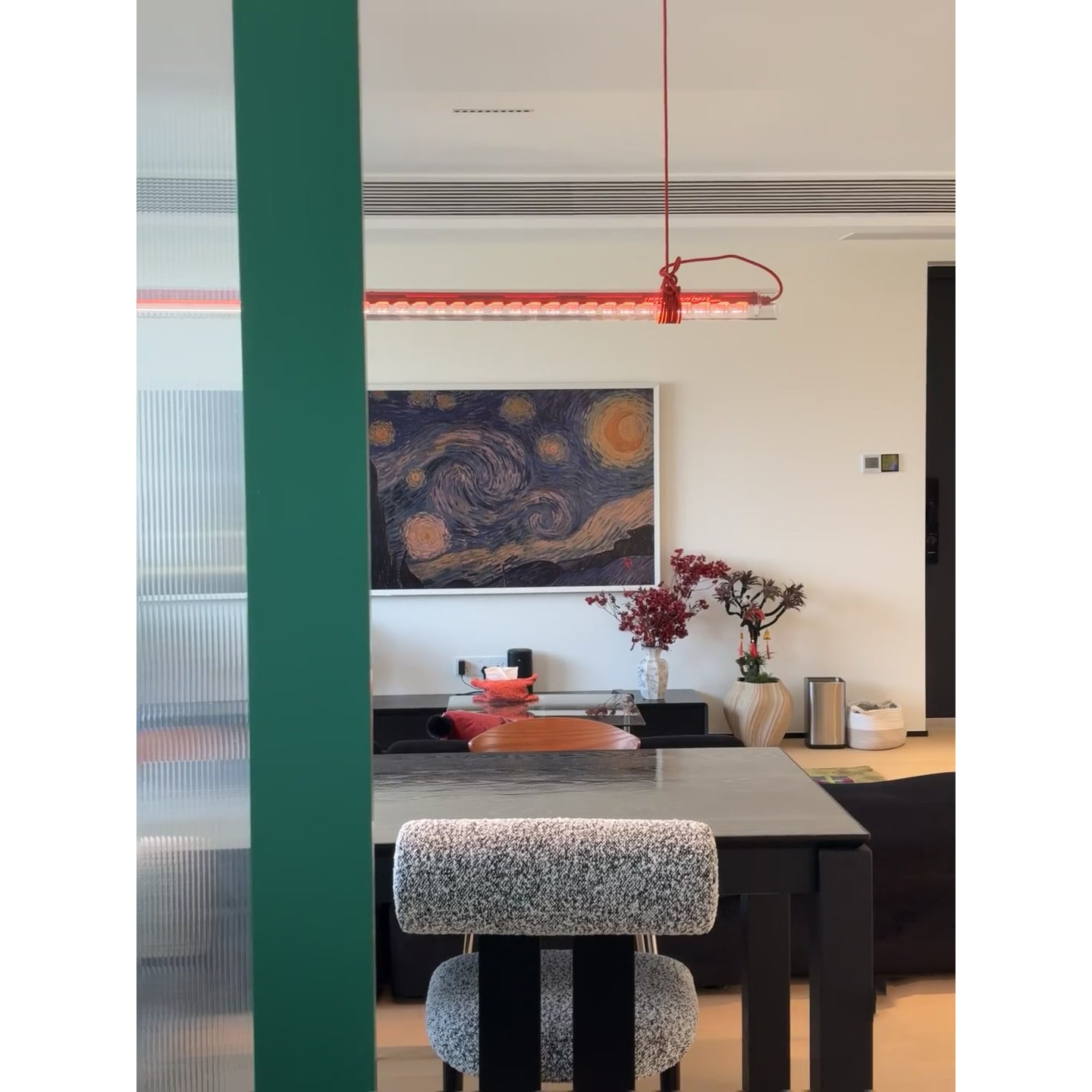 Angled view of the red glass pendant lamp.