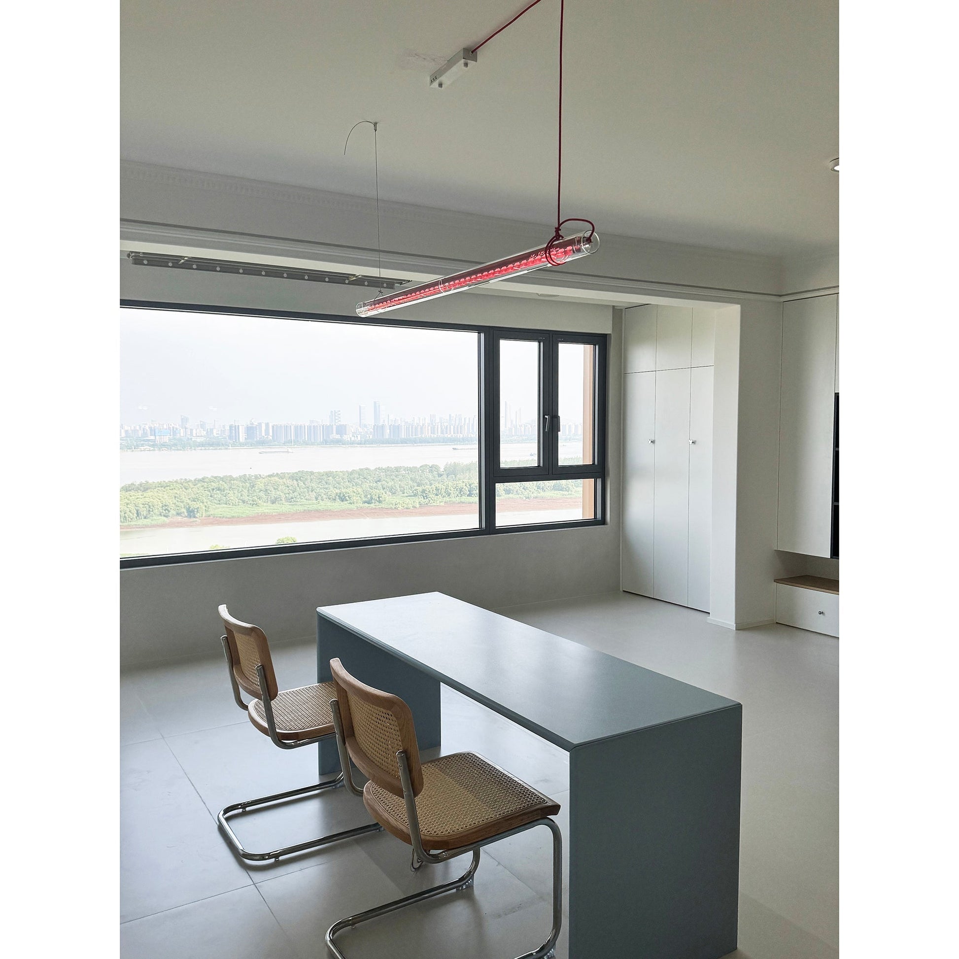 Angled view of the blue glass pendant lamp.