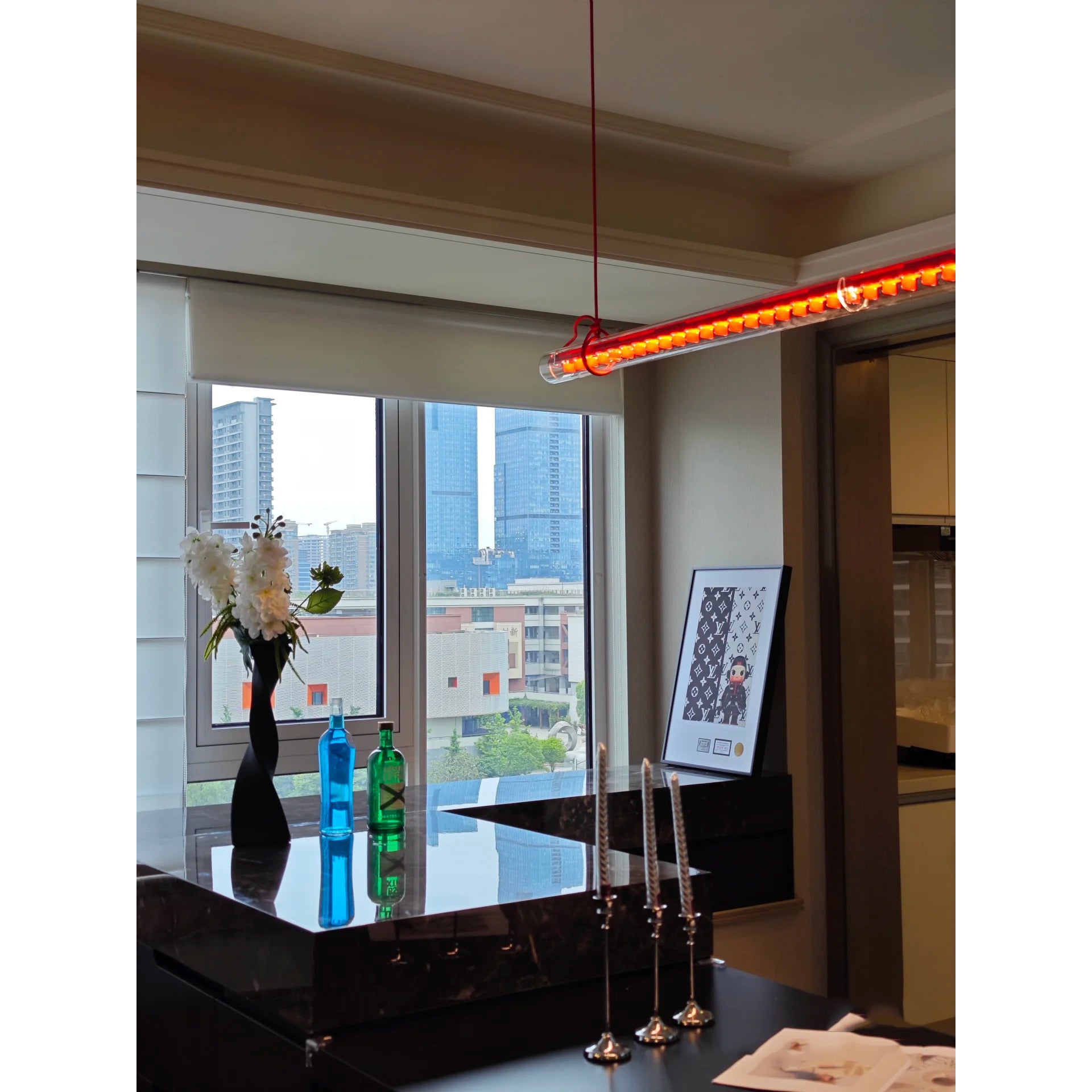 The 100cm version of the pendant lamp in a cozy space.
