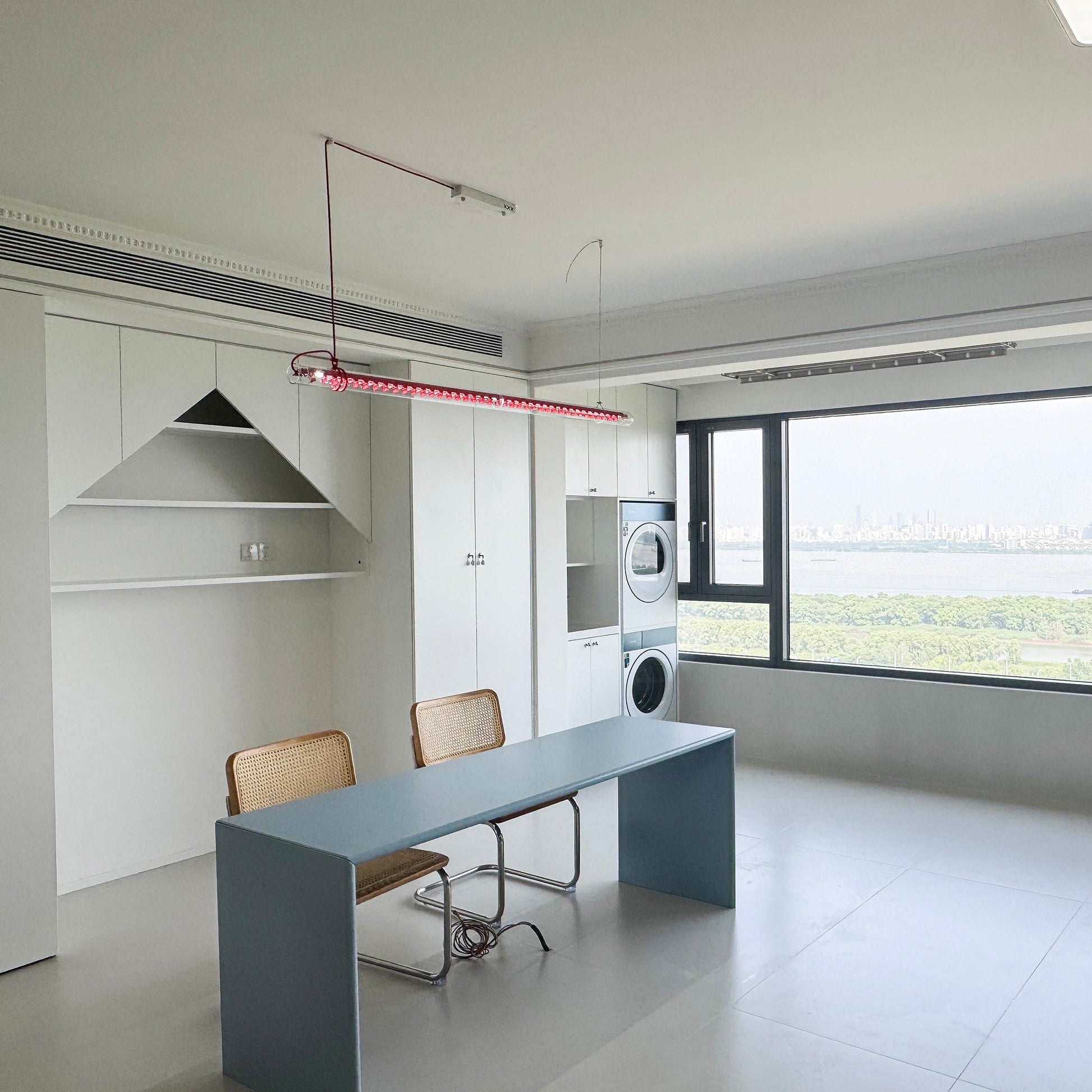 The pendant lamp providing ambient light in a living room.