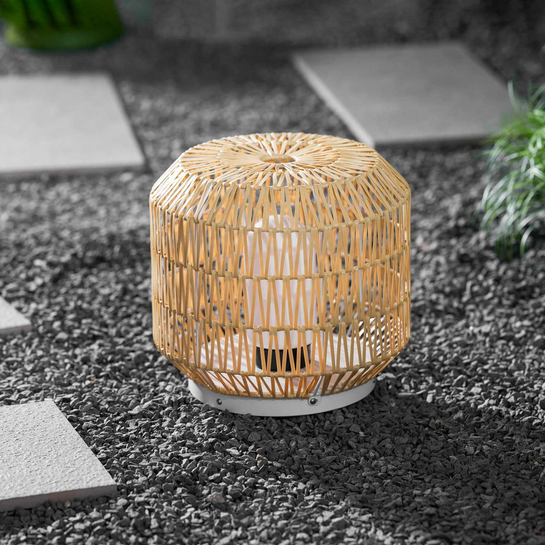 Close-up on the woven rattan body of the white lantern.