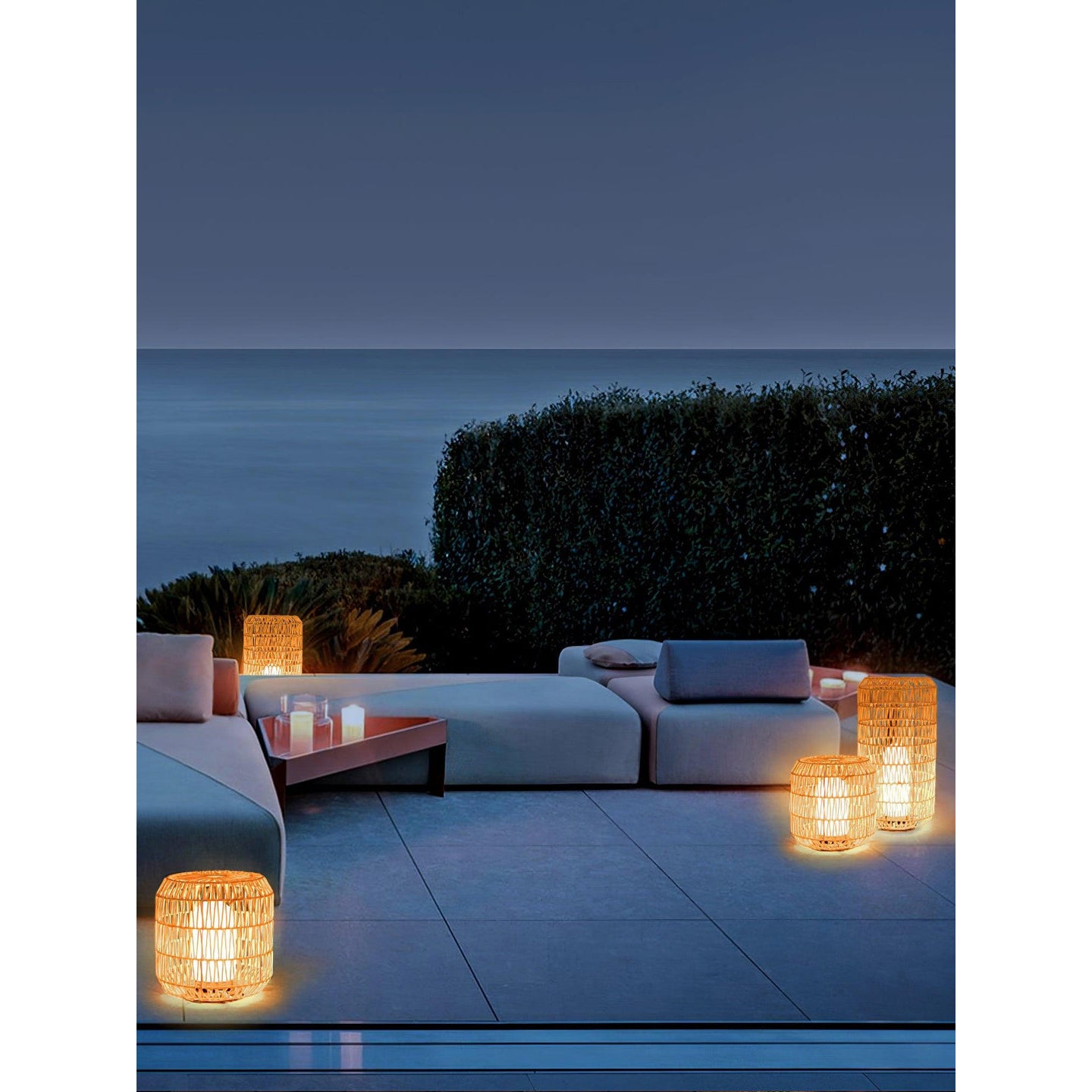 A pair of small Tulum Lanterns on an outdoor dining table.