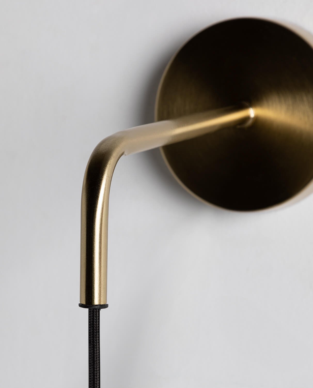 The Valenes Wall Lamp turned on, casting a warm glow.