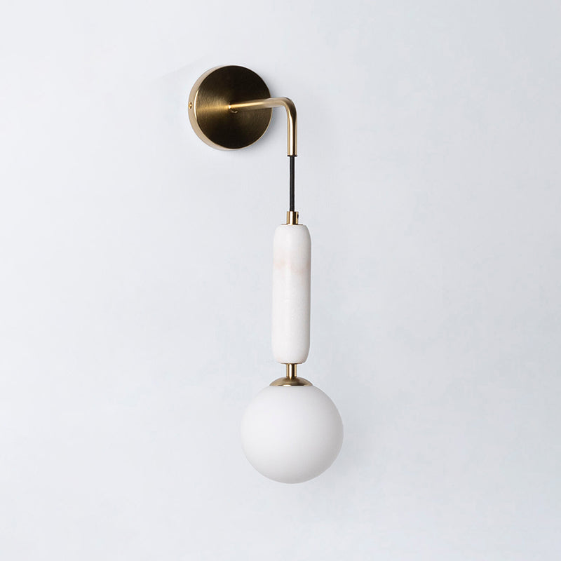 Lifestyle image of the Valenes Wall Lamp in a reading nook.