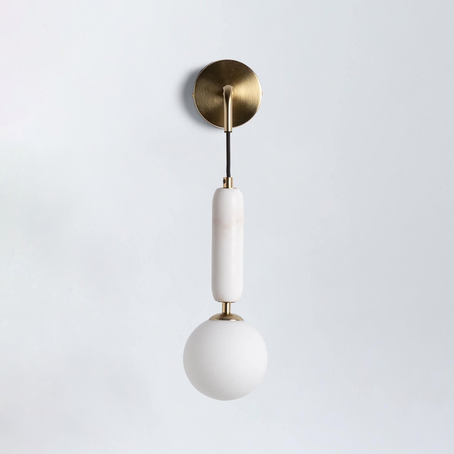 The Valenes Wall Lamp installed in a modern bedroom.