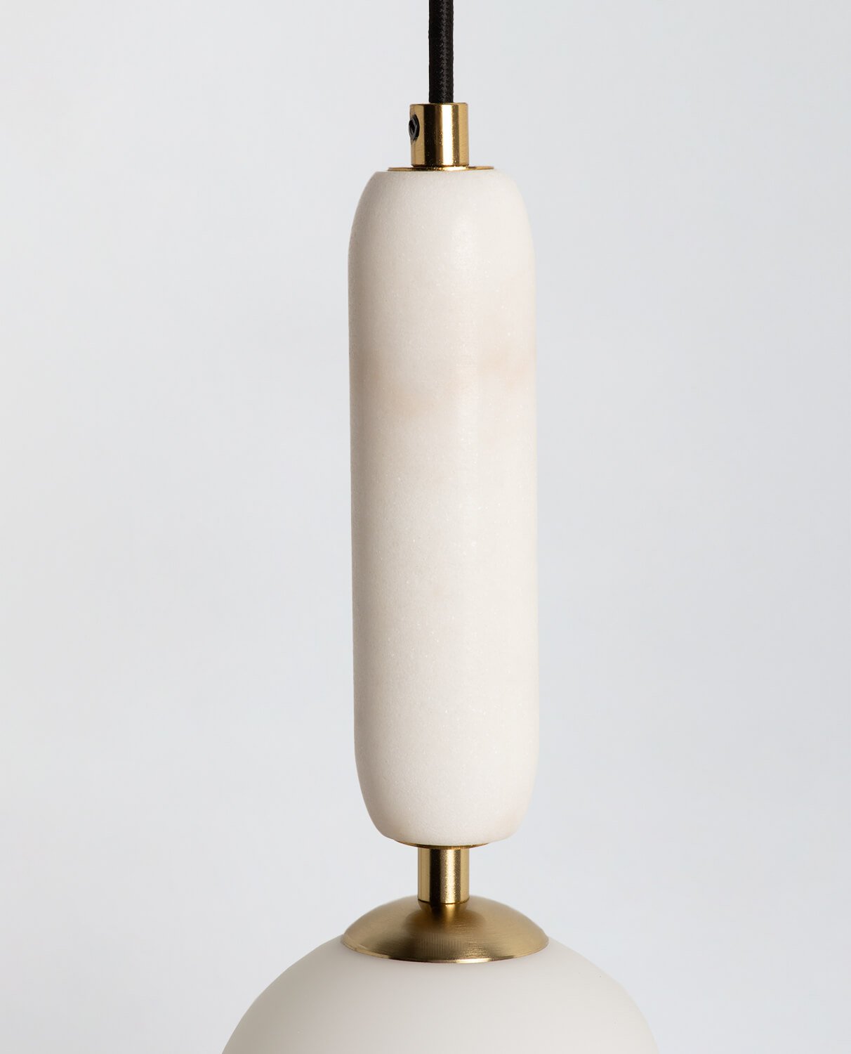 Detail shot of the natural marble veining on the lamp body.