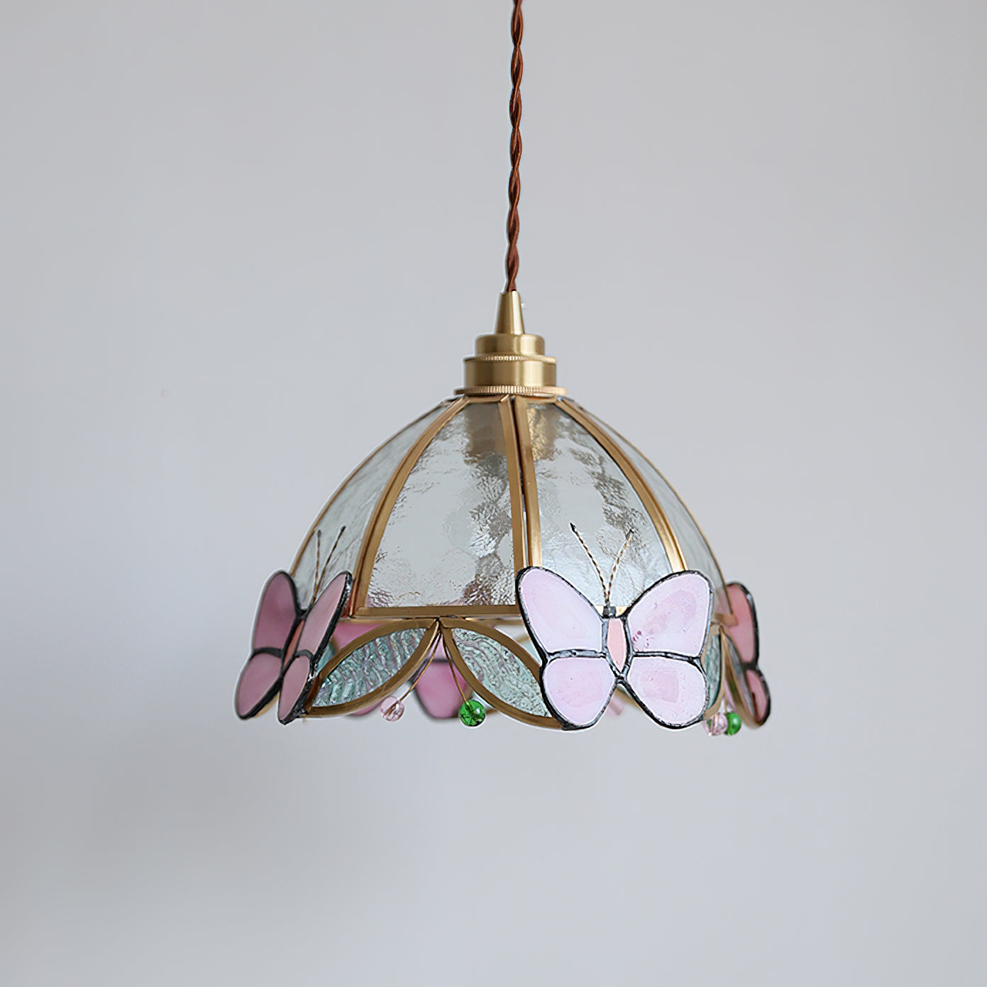 Valinte pendant light shown against a dark background to highlight its colors.
