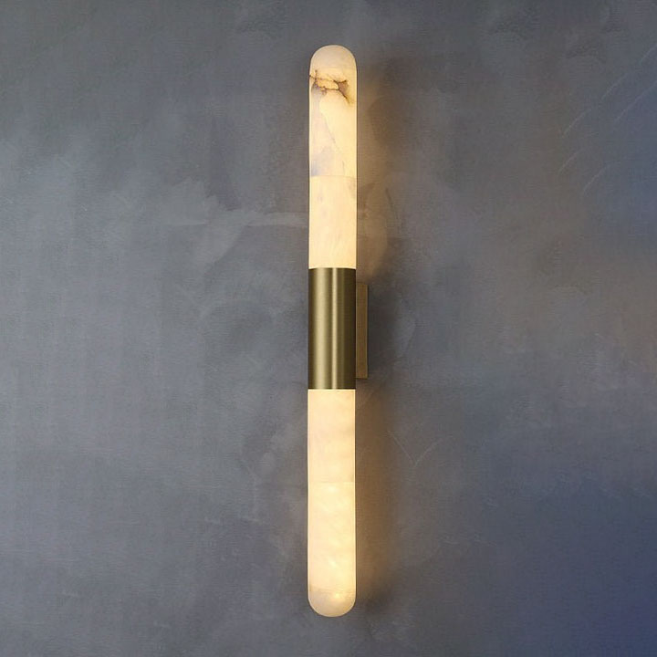 The Velin sconce in a living room setting next to a fireplace.