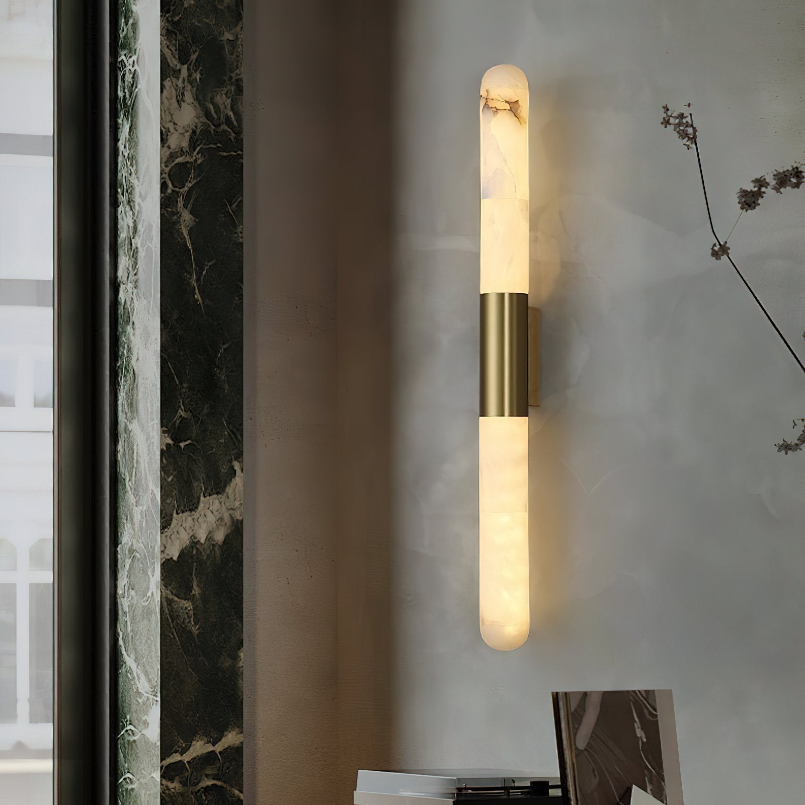 Detail shot of the warm gold metal cuff on the alabaster tube sconce.