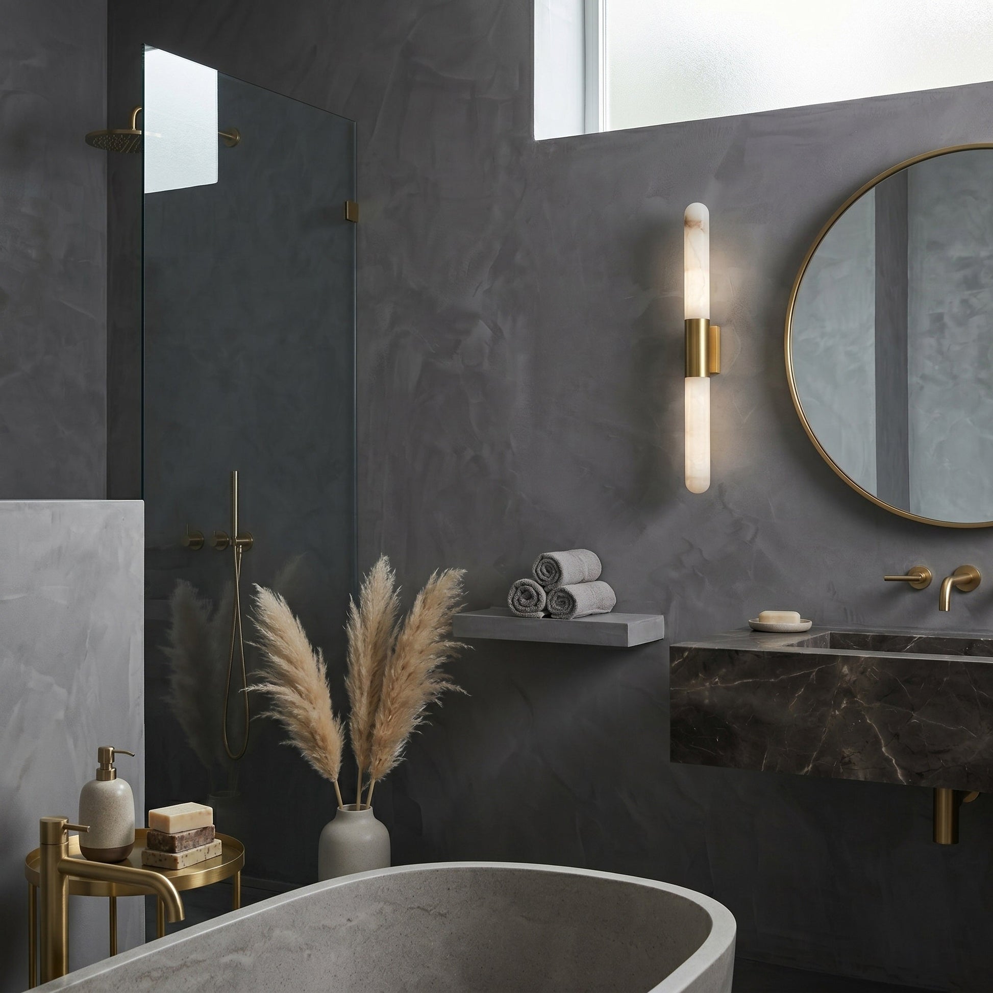 A pair of Velin alabaster sconces flanking a modern bathroom vanity mirror.