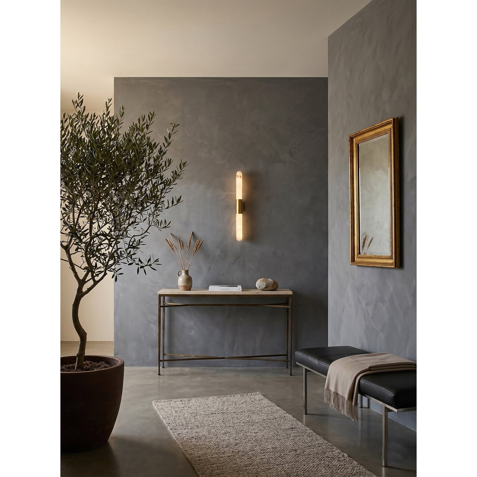 Angled view of the Velin sconce, showing its linear and minimalist design.
