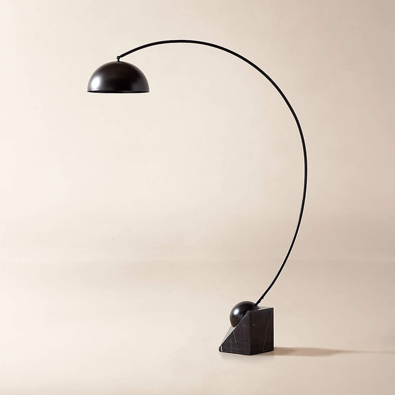 The heavy marble base of the Venus Floor Lamp on a wooden floor.
