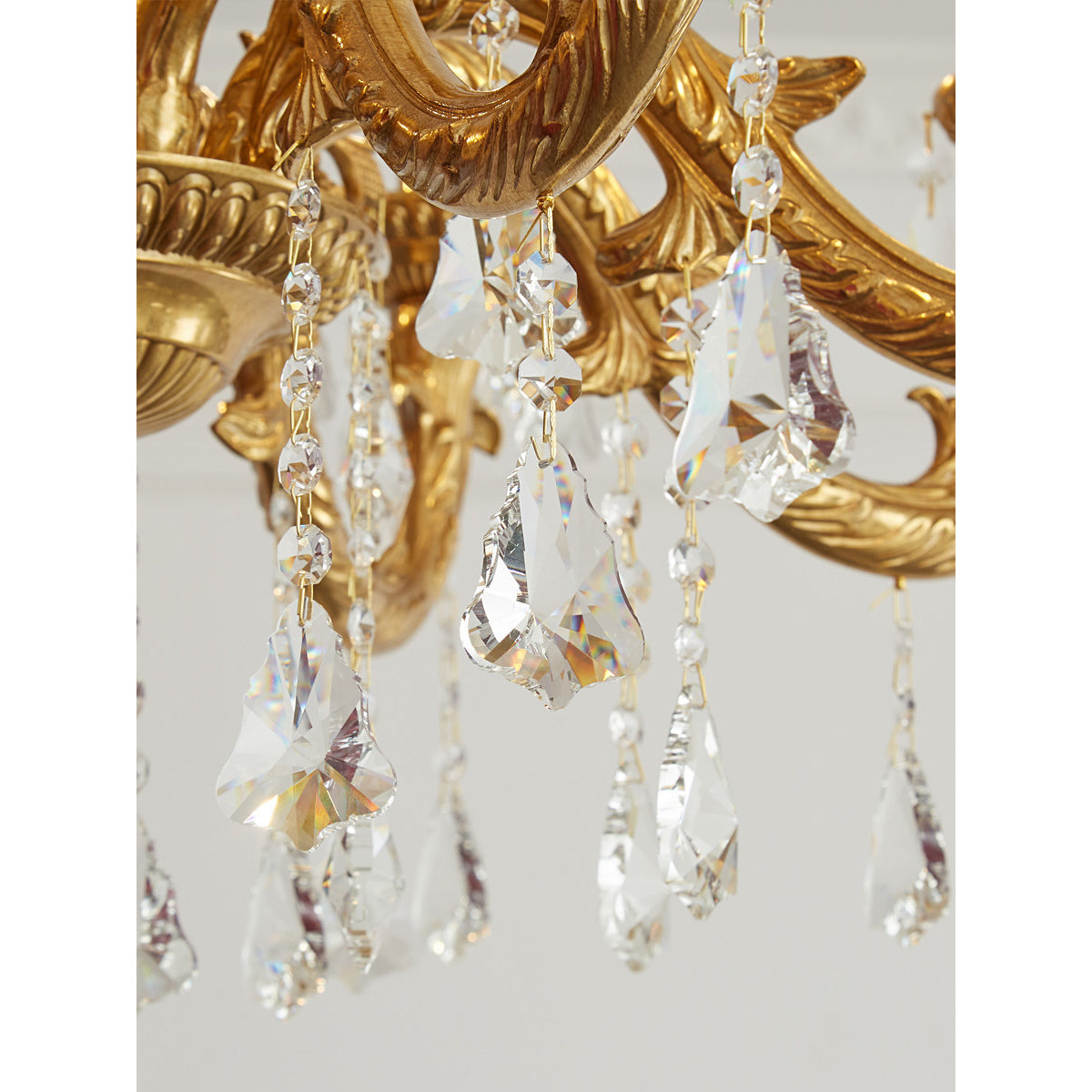 The ceiling canopy and suspension chain in matching brass finish.