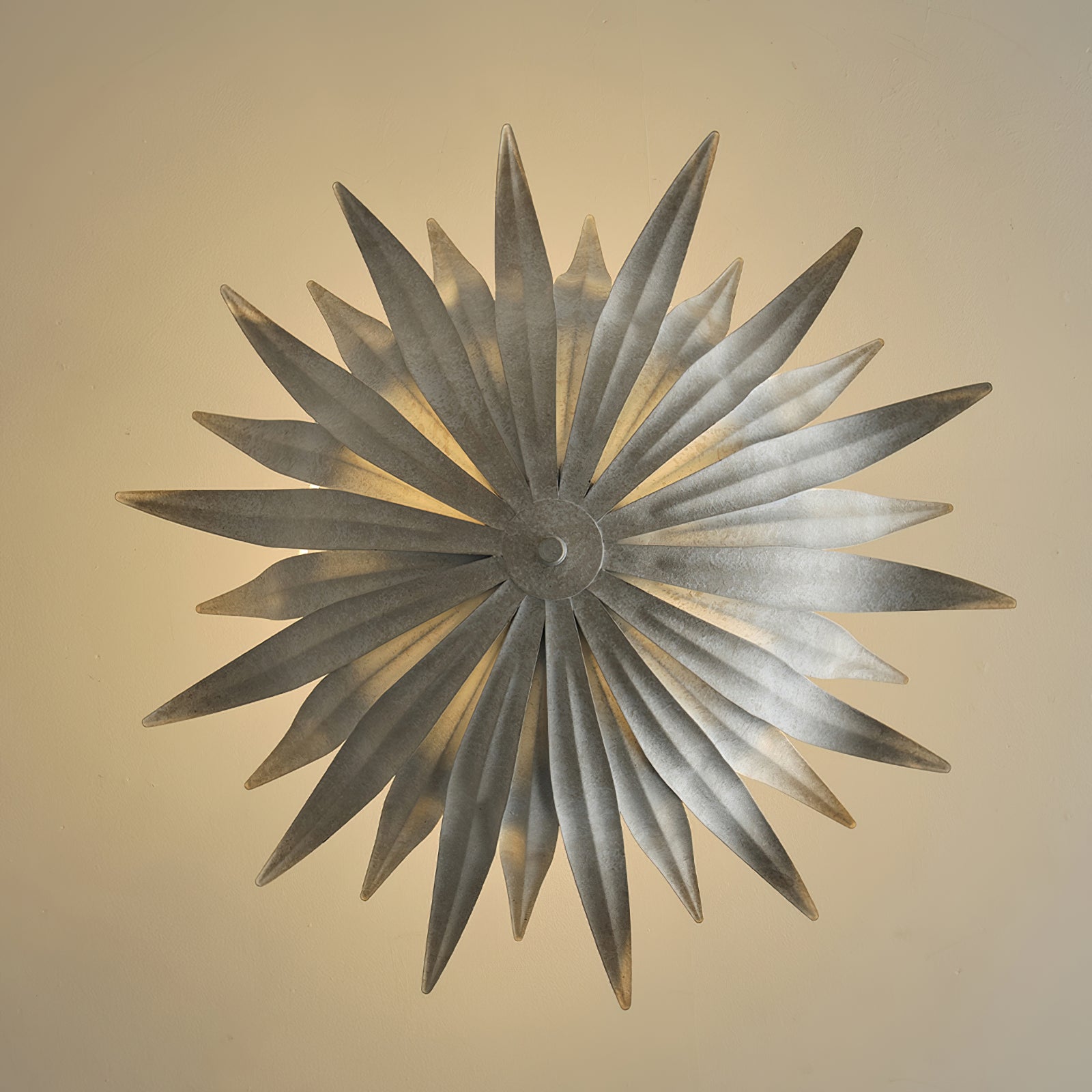 Large gold Vicenzio pendant light styled over a round dining table.