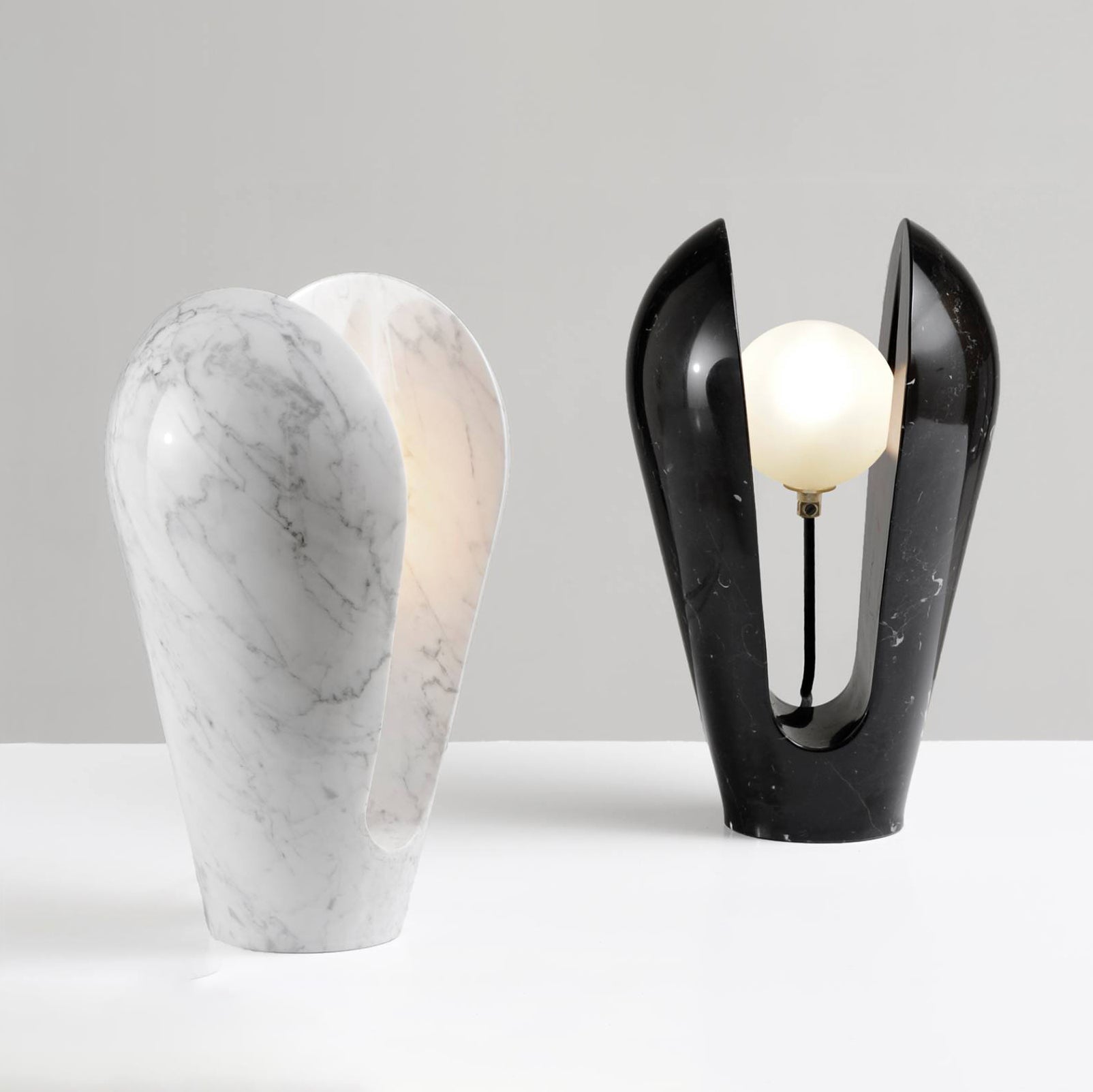 The Victoire lamp casting a warm, ambient glow in a dimly lit room.