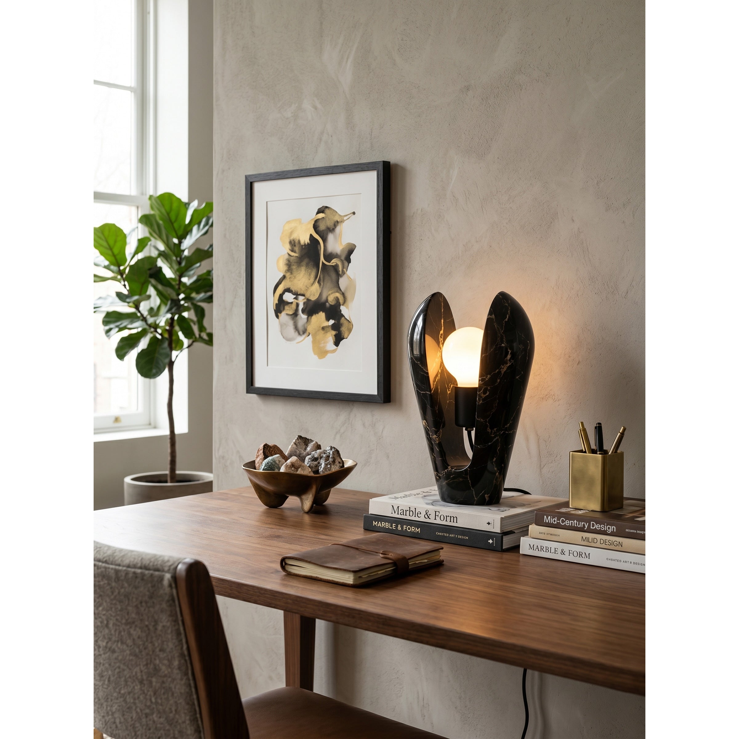Victoire Marble Table Lamp against a dark background to highlight its form.