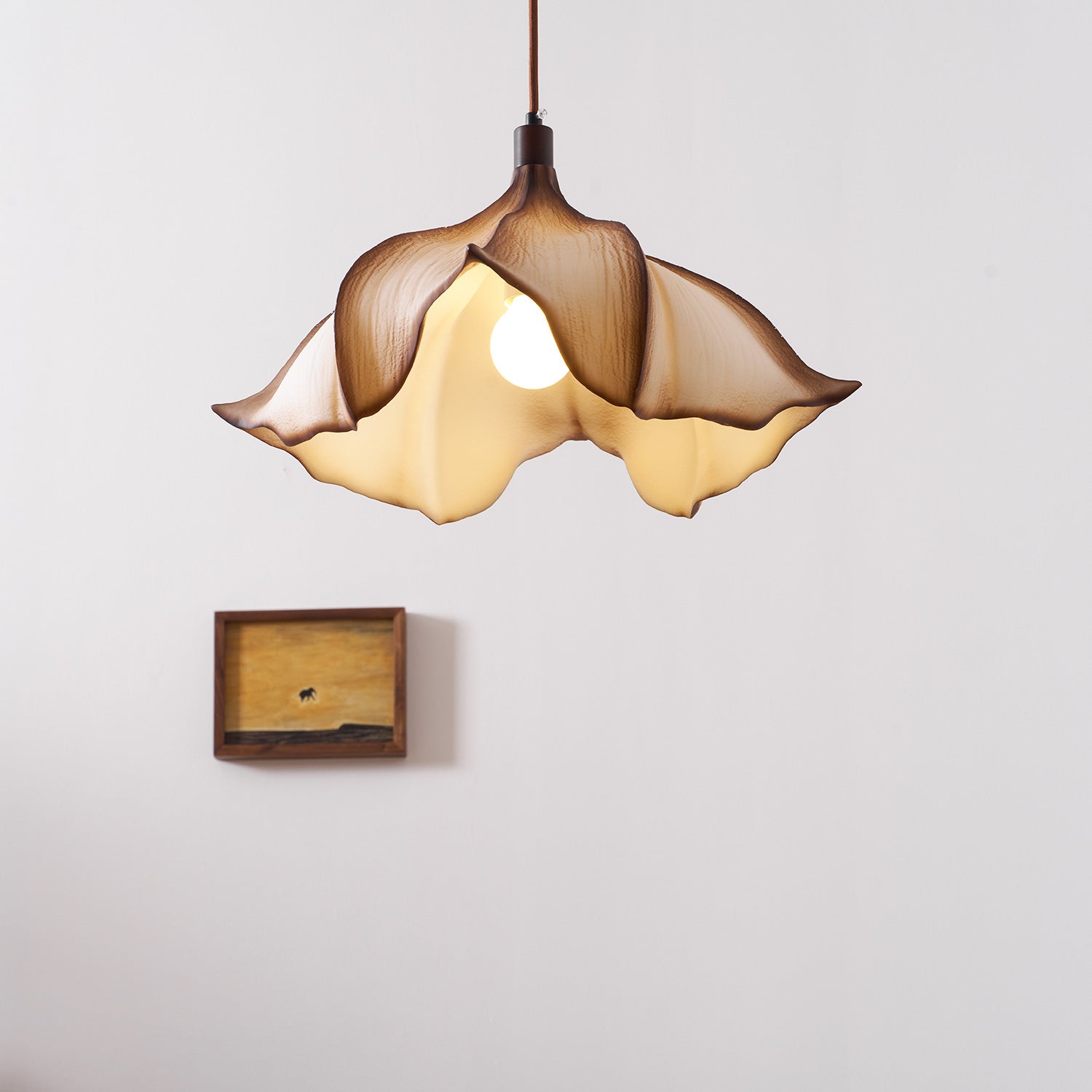 The sculptural form of the Viscontea Pendant Light unlit during the day.