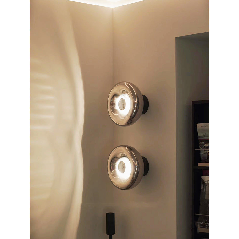 Lifestyle image of the Void Sconce in a modern living room.