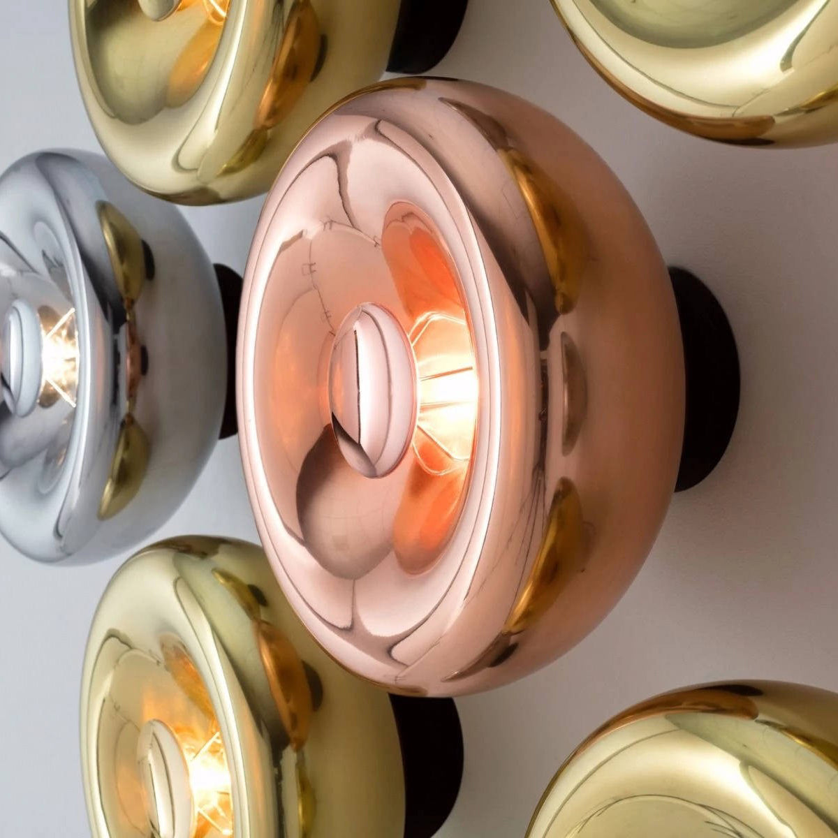 Front view of the minimalist Void Surface Sconce in gold.