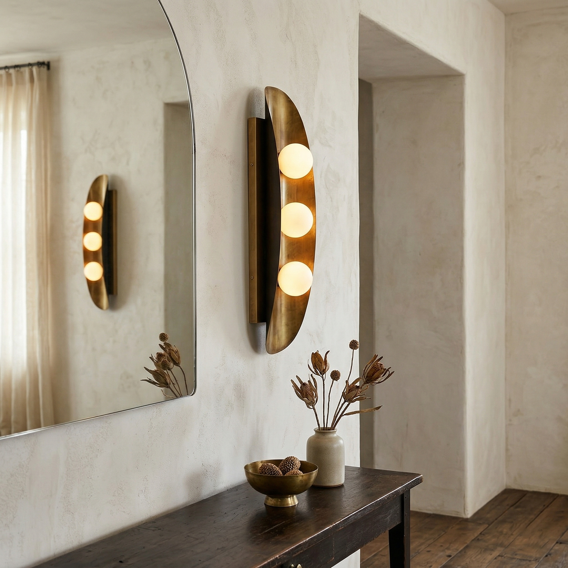 Close-up of the Hopper Wall Lamp's brass body and glass shade.