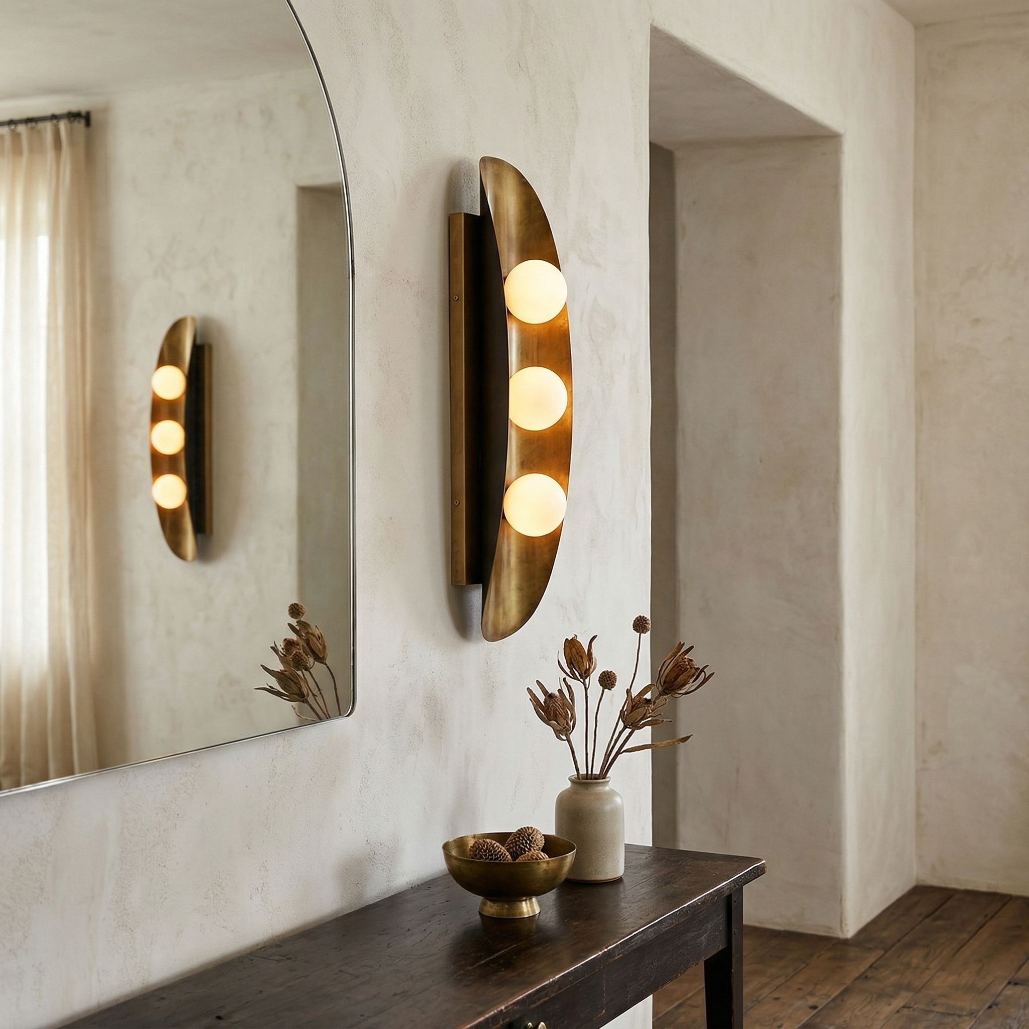 Close-up of the Hopper Wall Lamp's brass body and glass shade.