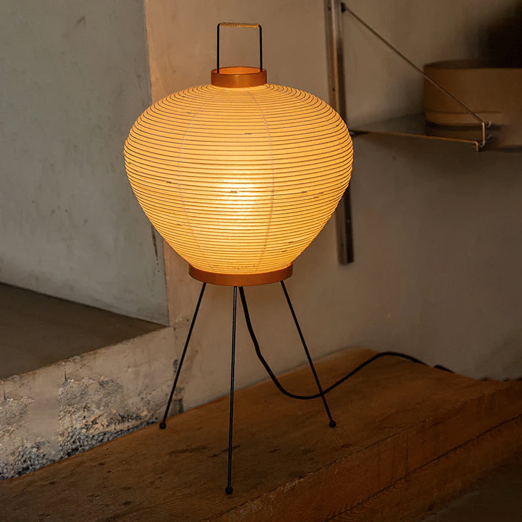 The lamp illuminating a cozy corner of a room.