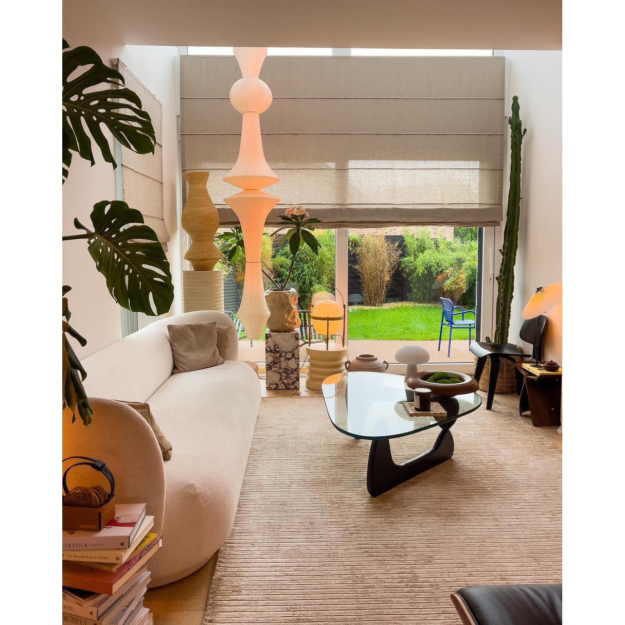 The sculptural form of the Washi Paper E Pendant Lamp in a bright room.