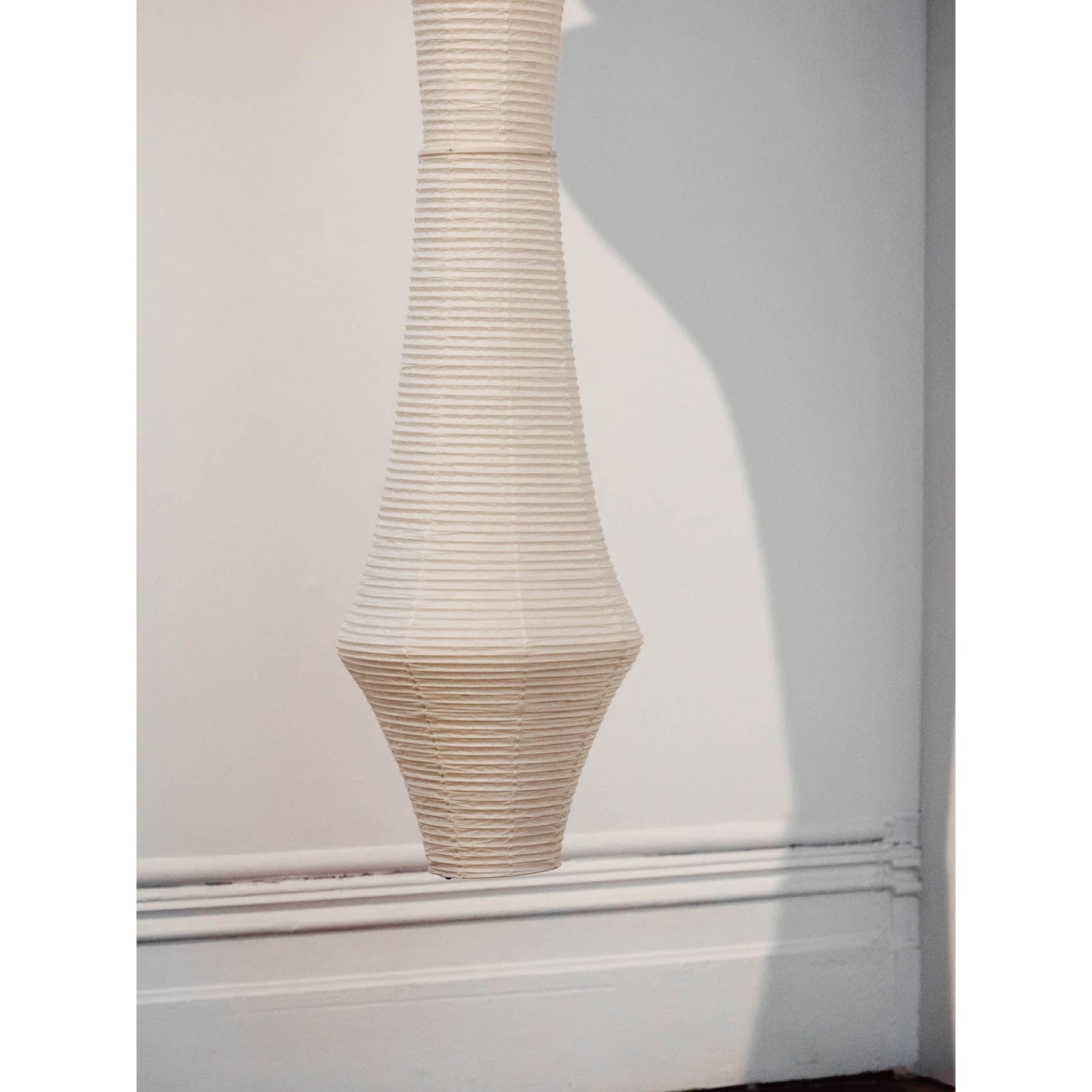 The warm light filtering through the paper shade.
