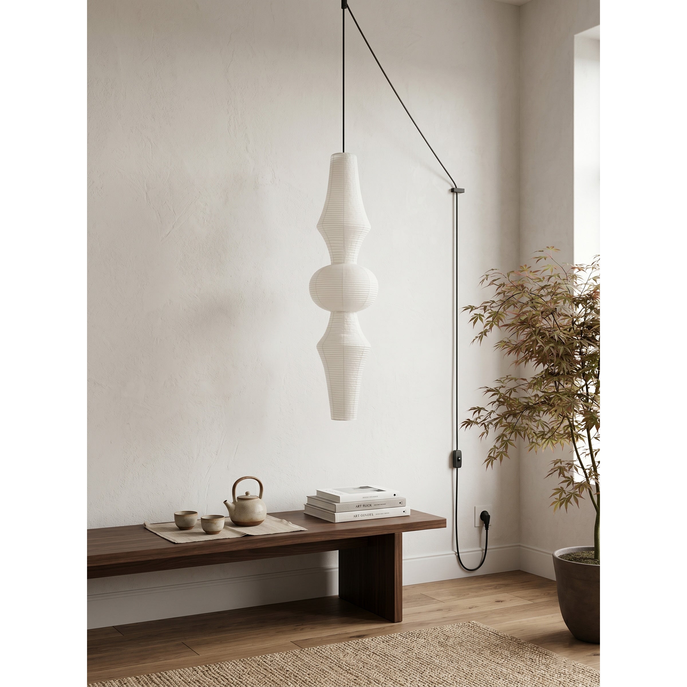 Washi Paper Pendant Swag Light against a dark wall to highlight its glow.