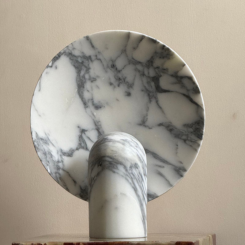 Beige travertine lamp, close-up on the fan-like shape.
