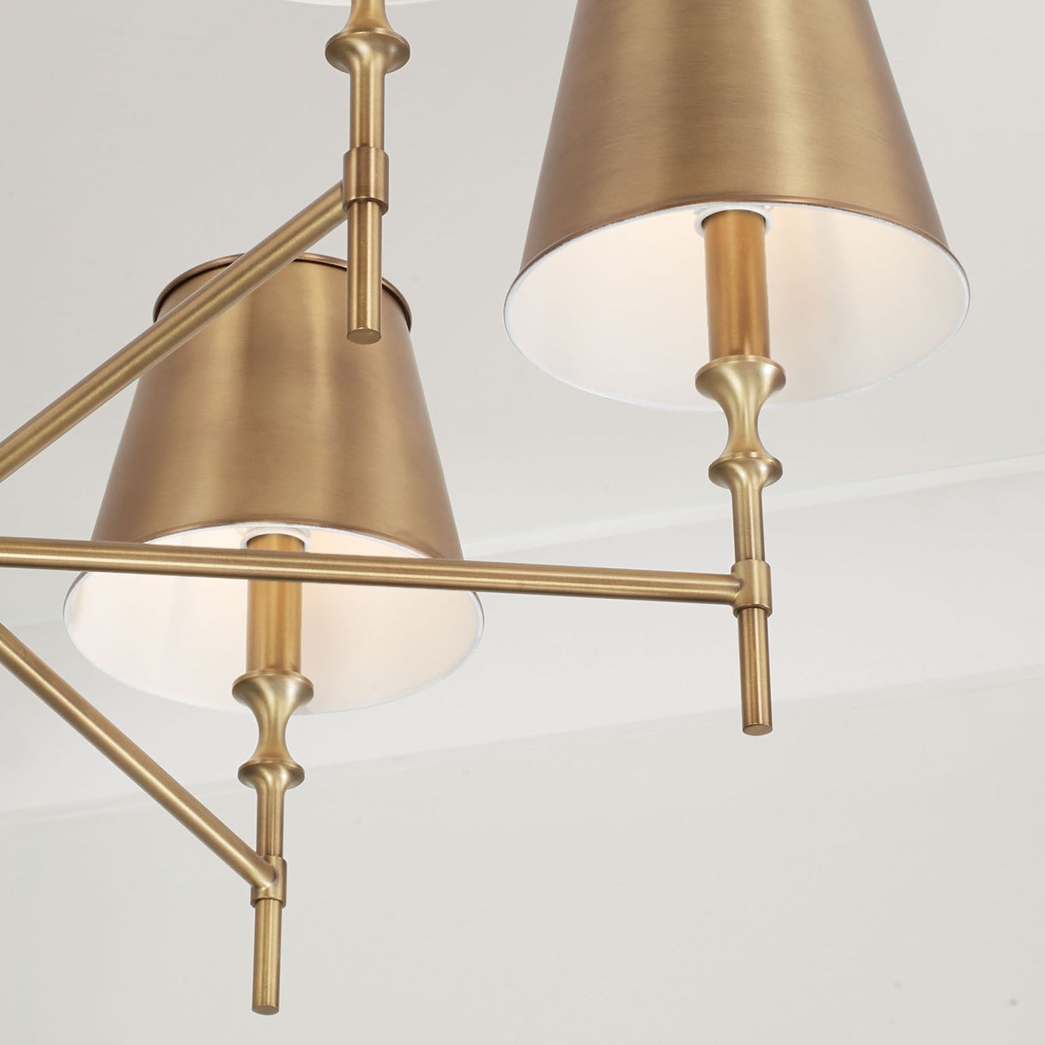 The Whitney Chandelier unlit in a brightly lit, elegant space.