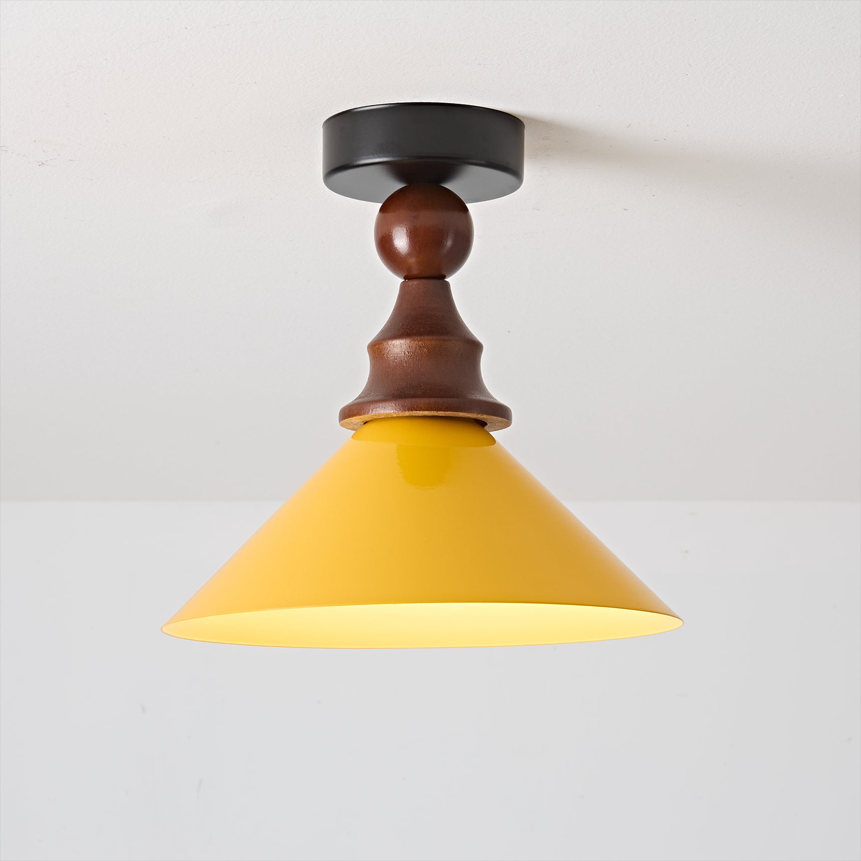 Detail shot of the yellow metal shade of the Wilken Ceiling Lamp.