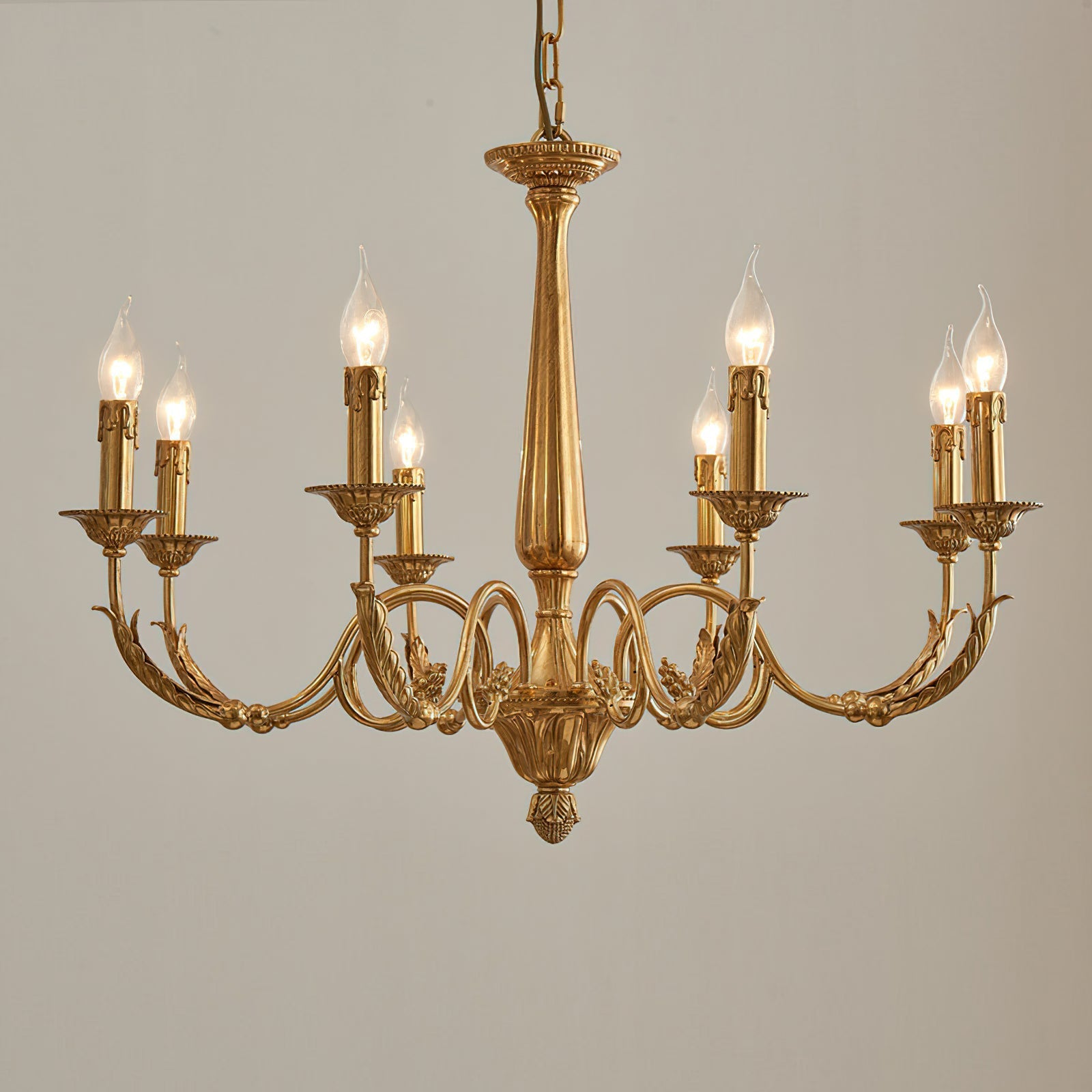 The chandelier's hanging chain and canopy in a matching brass finish.