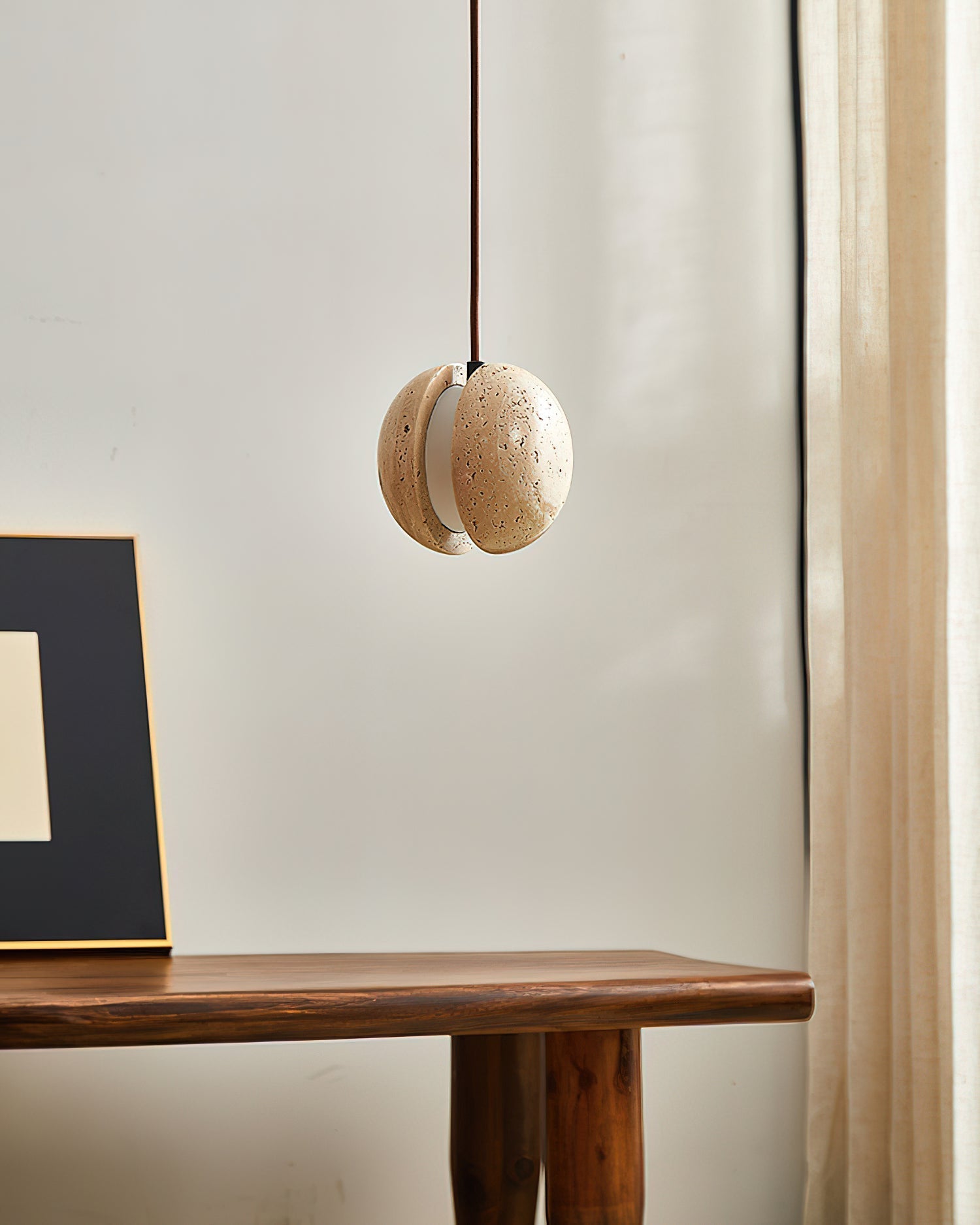 Lifestyle image of the Wisteria Pendant Lamp hanging in a modern room.