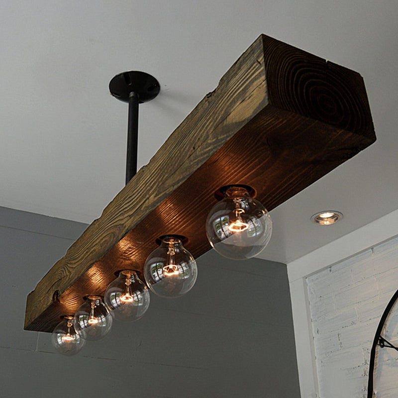Close-up of the hand-aged walnut wood grain on the chandelier beam.