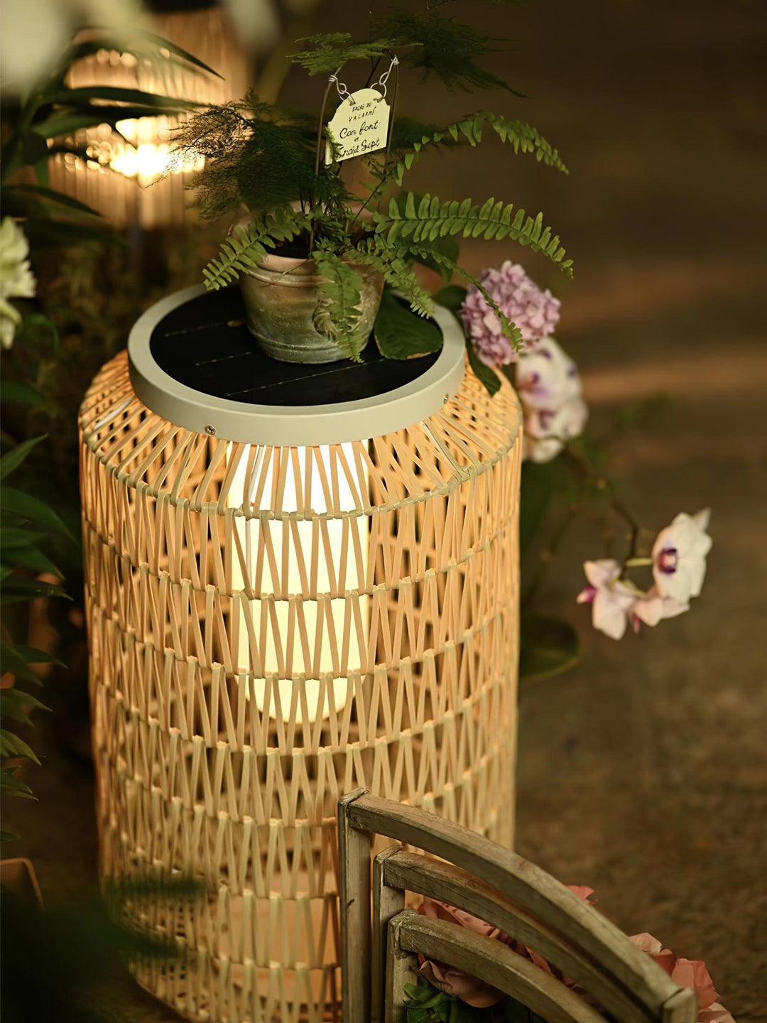 Woven rattan outdoor lamp with a natural finish.